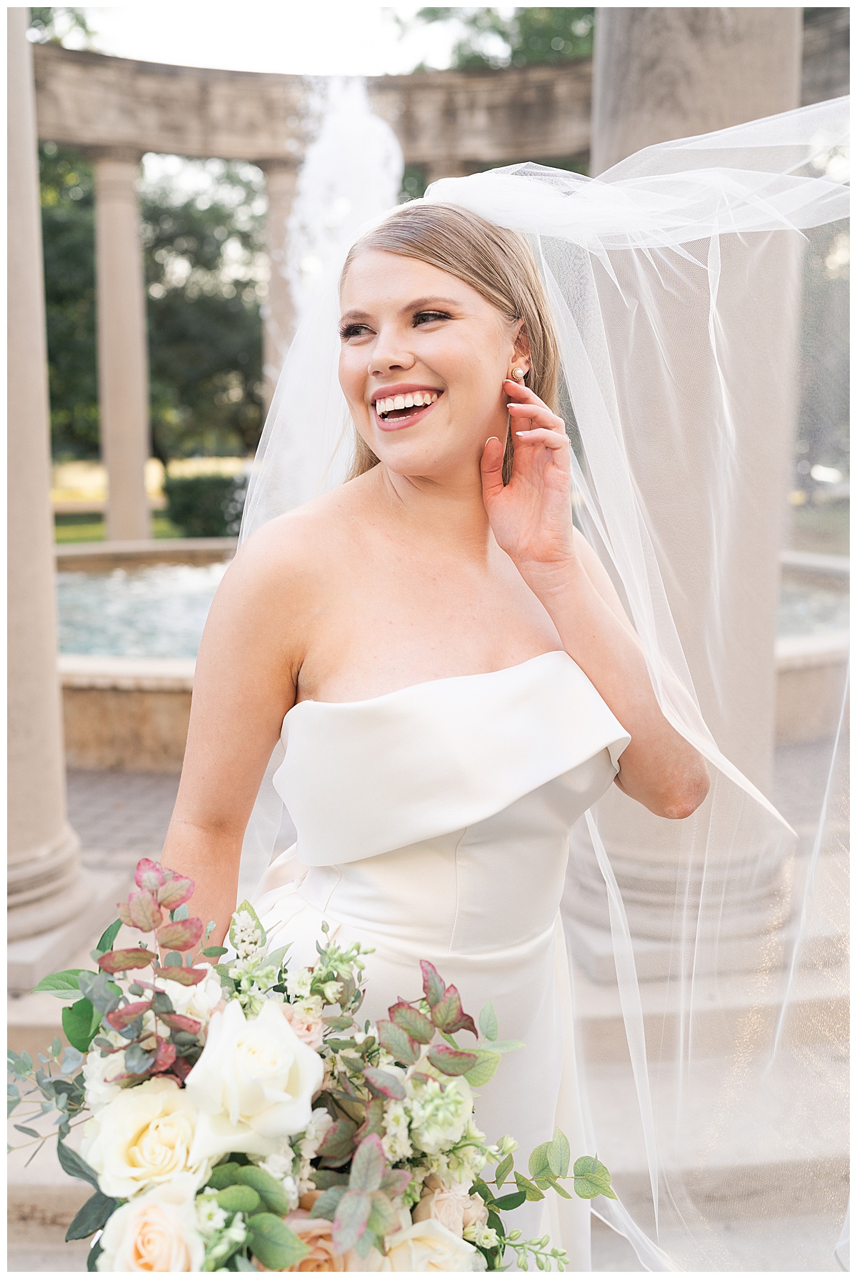 Brides smiles big and grabs earrings for Swish & Click Photography