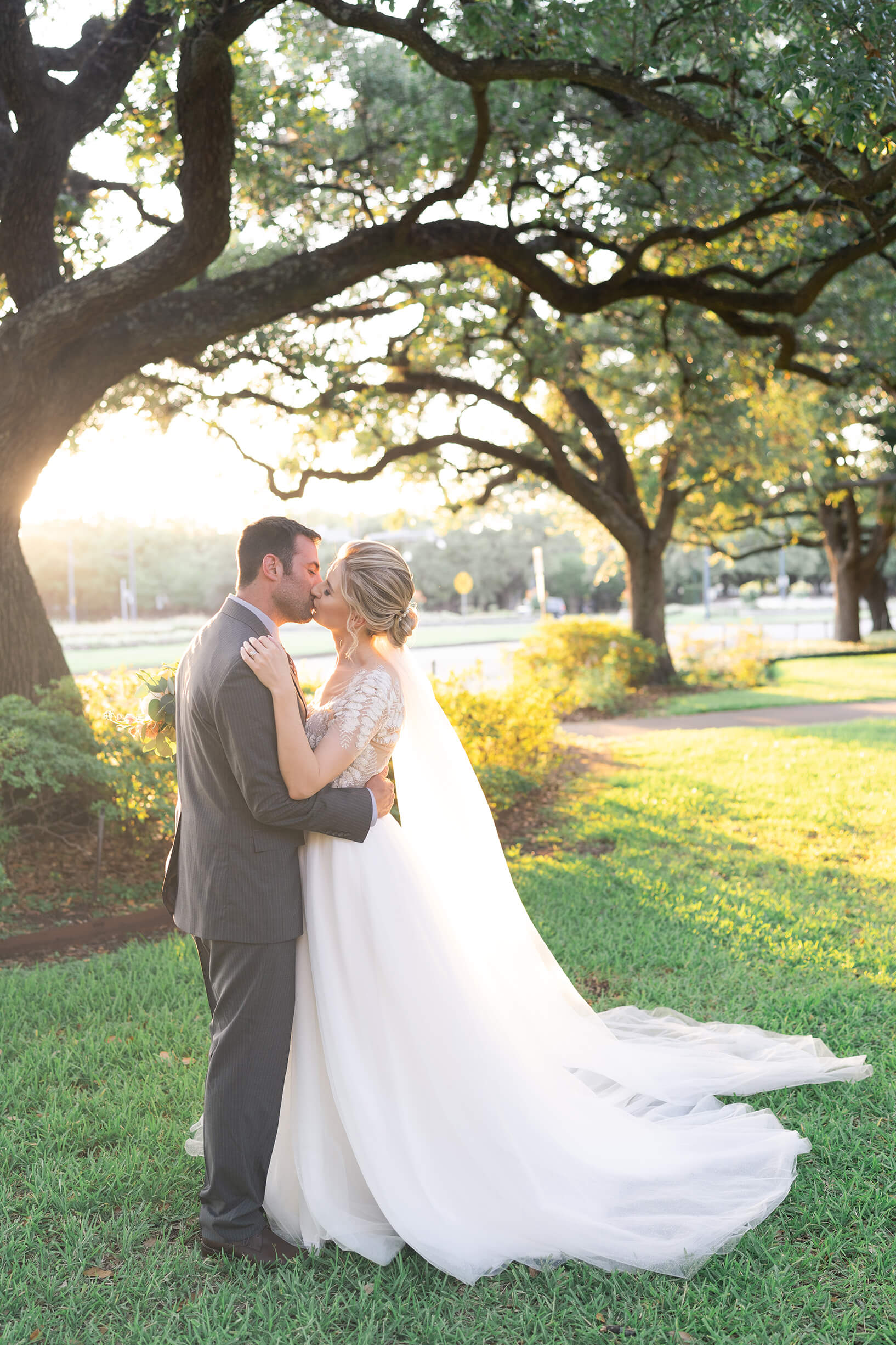 bride and groom kiss on their wedding day at the Peach Orchard in Houston Texas by Swish and Click Photography