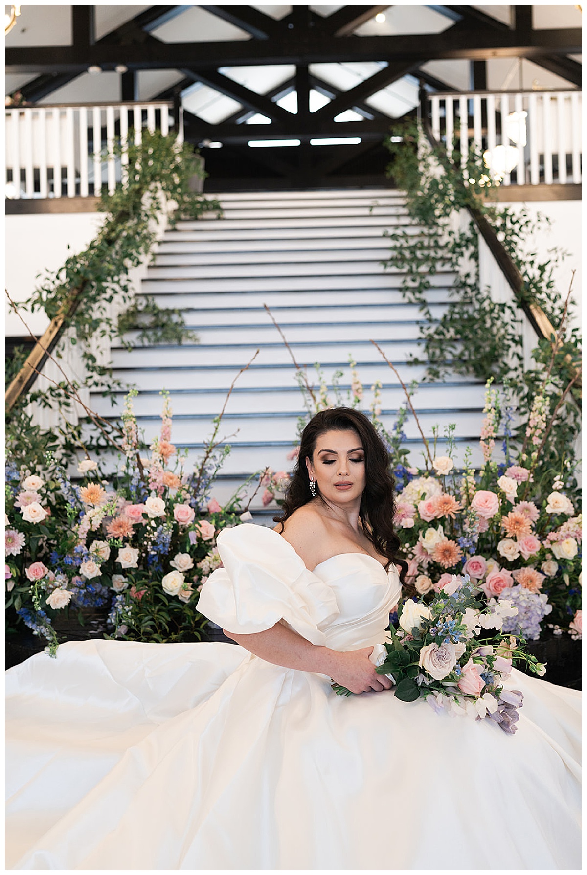 Woman holds floral bouquet and sits on floor for Houston’s Best Wedding Photographers