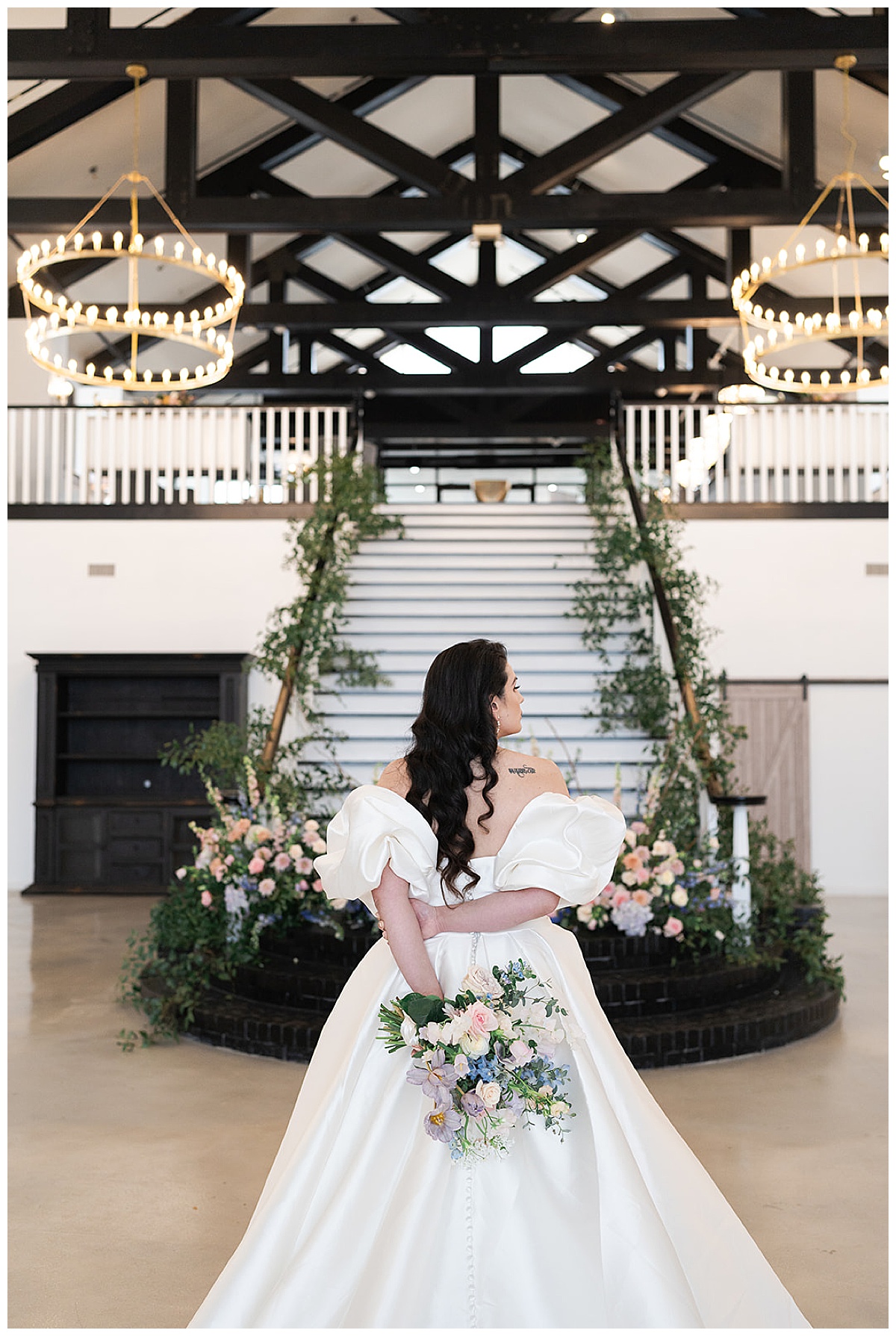 Bride stands in front of grand staircase for Swish & Click Photography