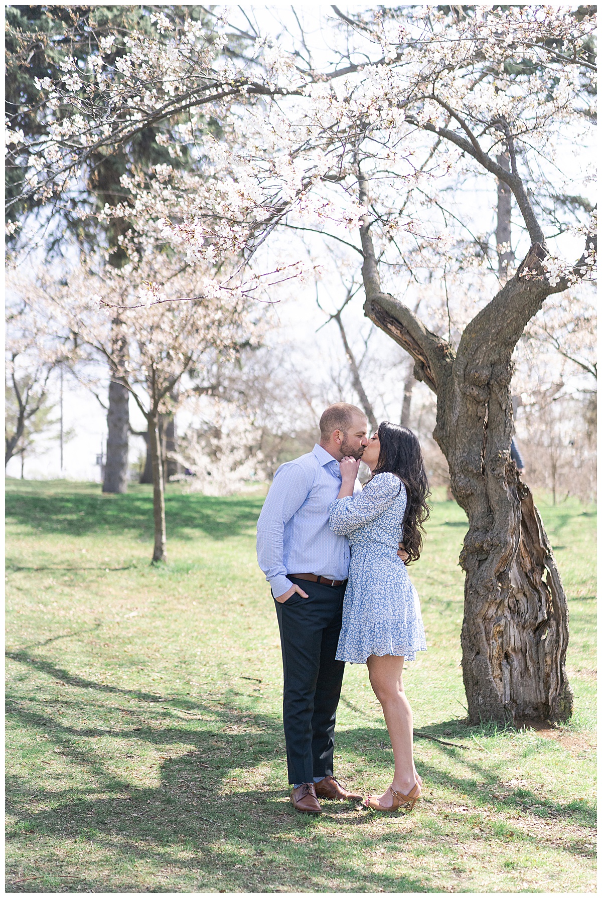 Couple hold one another close and share a kiss for Toronto Wedding Photographer
