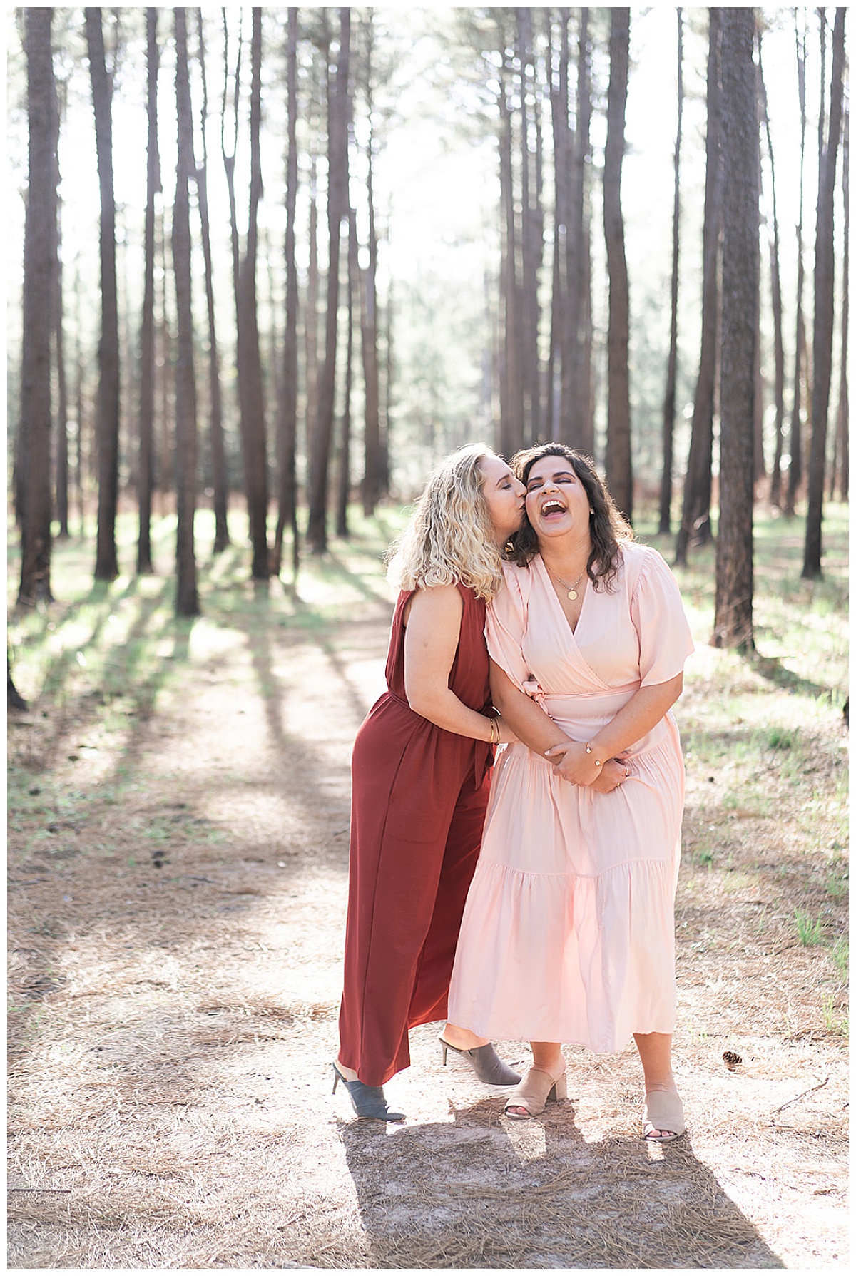 Women kiss one another for WG Jones Park Engagement Session 