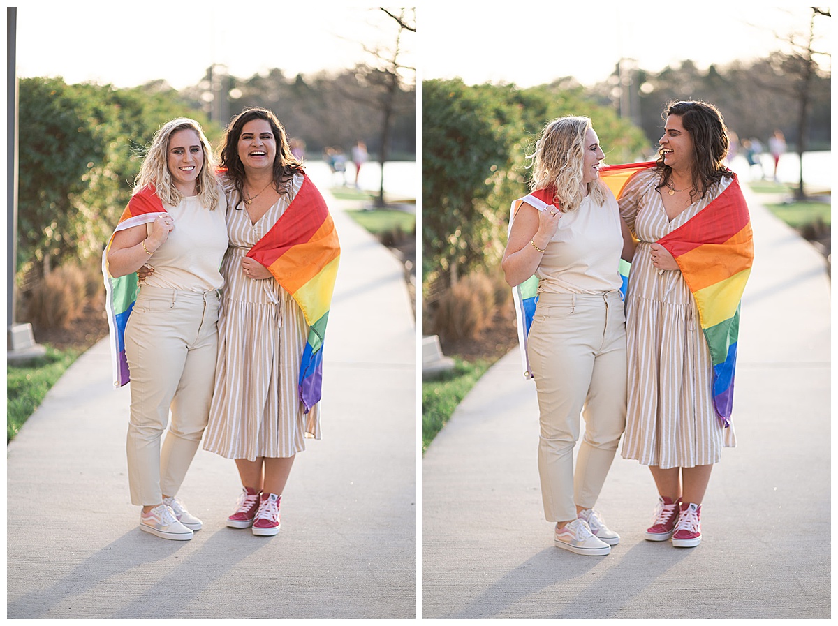 Happy couple wrap each other in a Pride flag for Swish & Click Photography