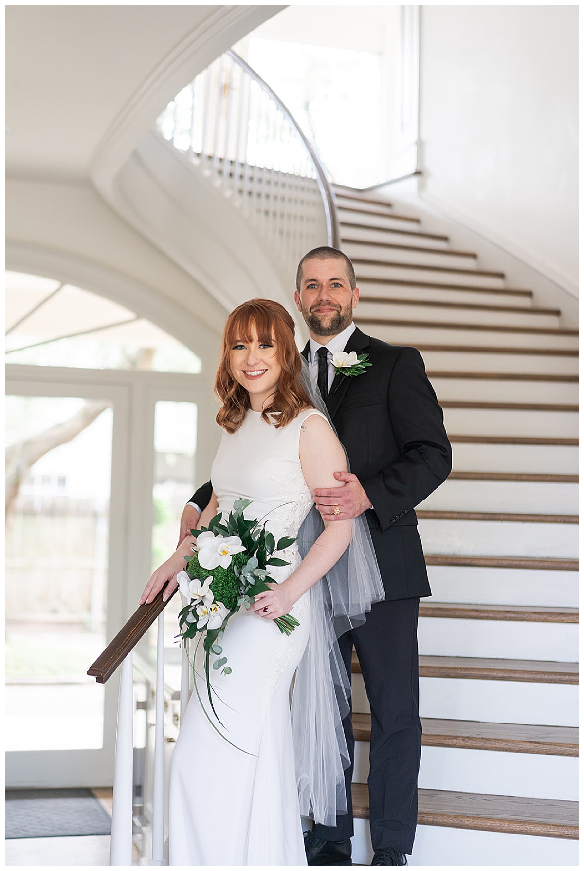 Husband and wife stand on stair case for Houston’s Best Wedding Photographers