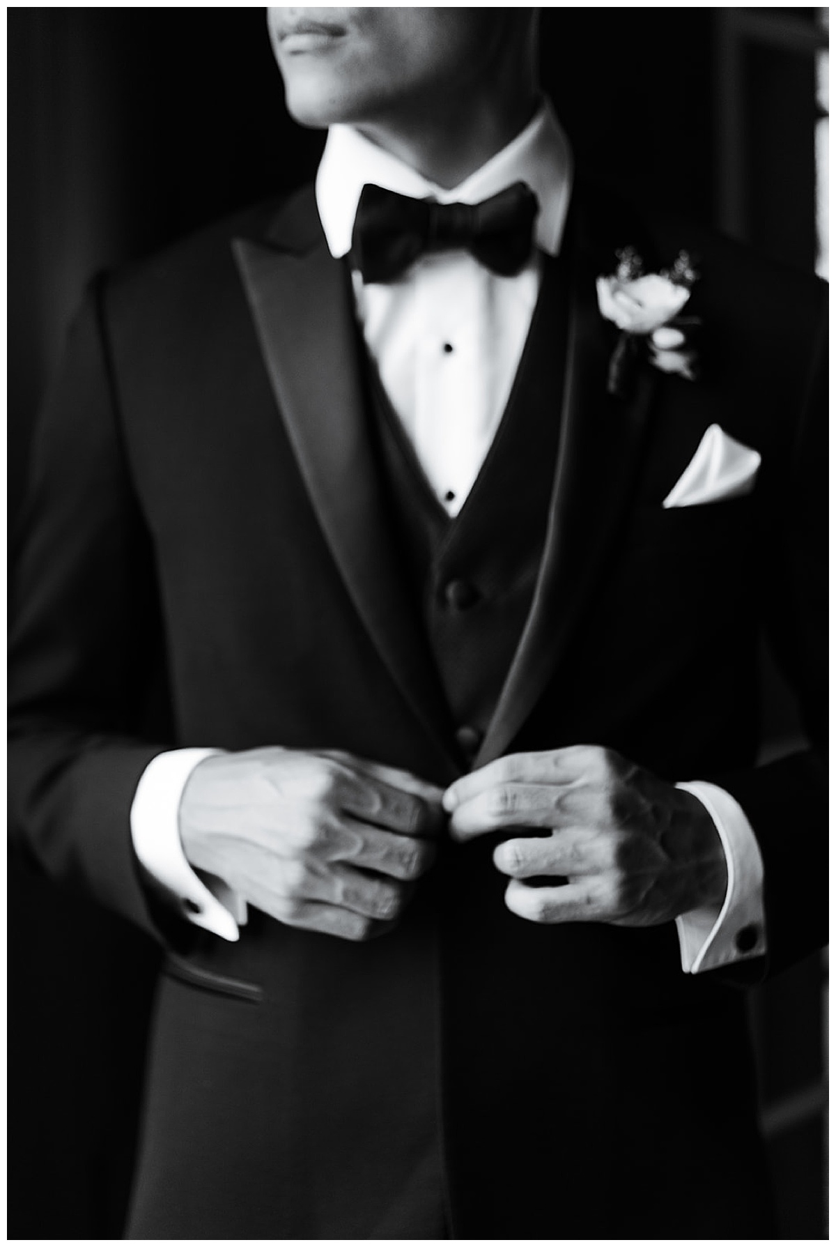 Groom adjusts suit buttons for Editorial at Villa Montalvo