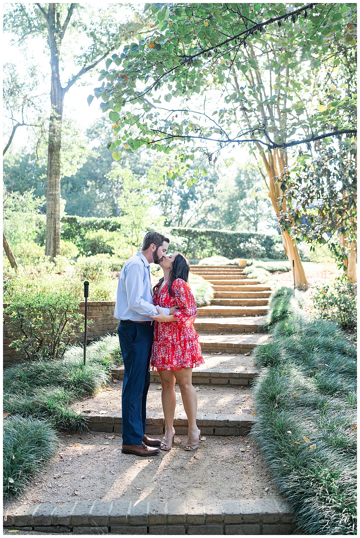Man and woman share a kiss at the bottom of the stairs for Houston’s Best Wedding Photographers