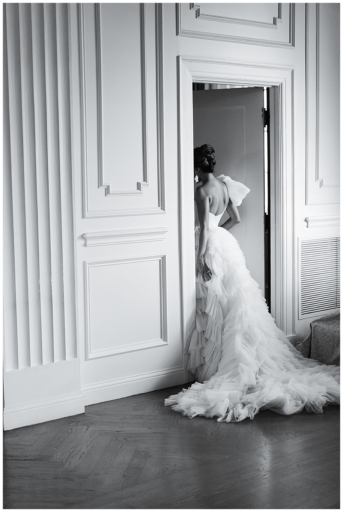 woman walks into a door wearing a bridal gown for Editorial at The Mason