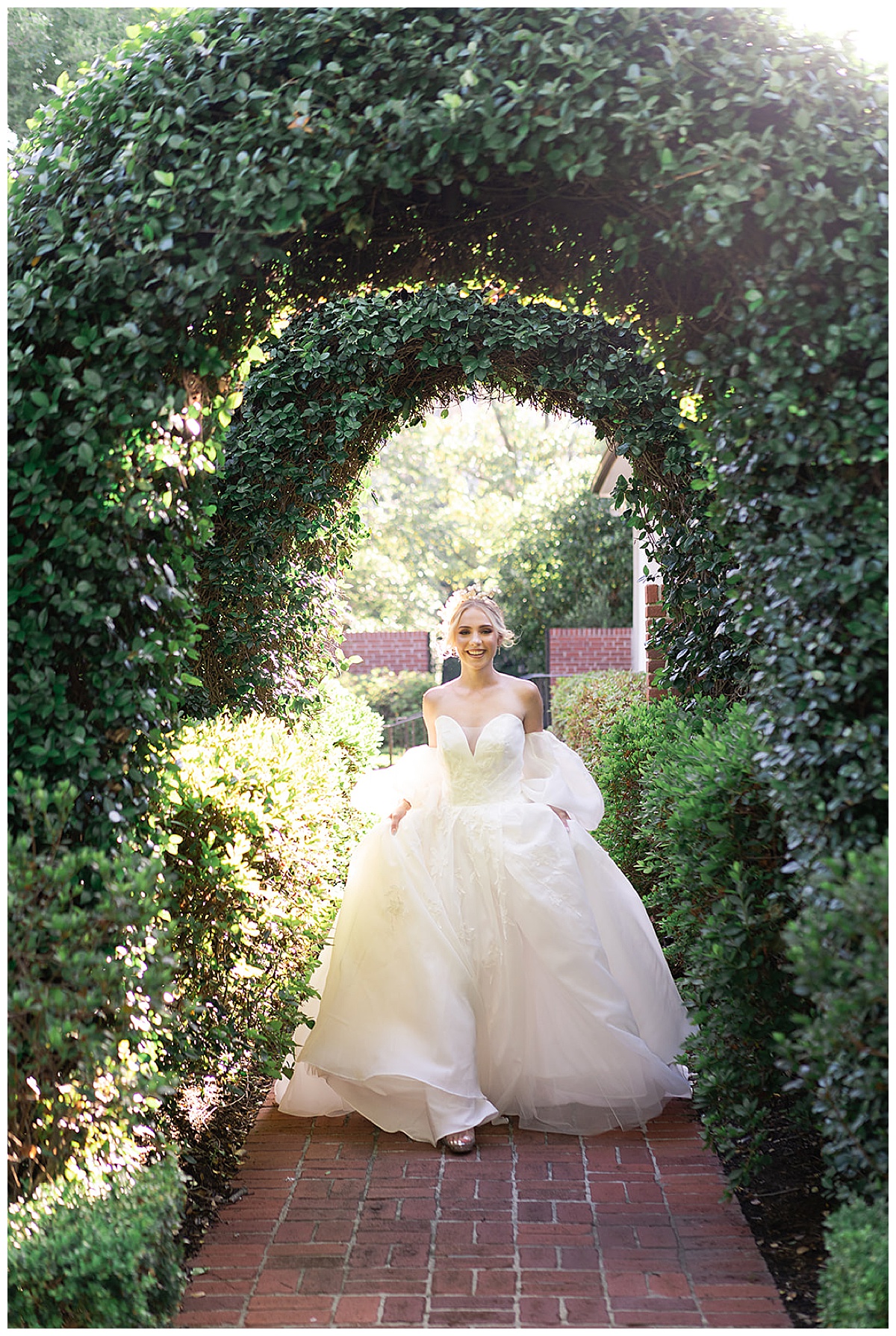Bride runs through walkway of greenery for Houston’s Best Wedding Photographers