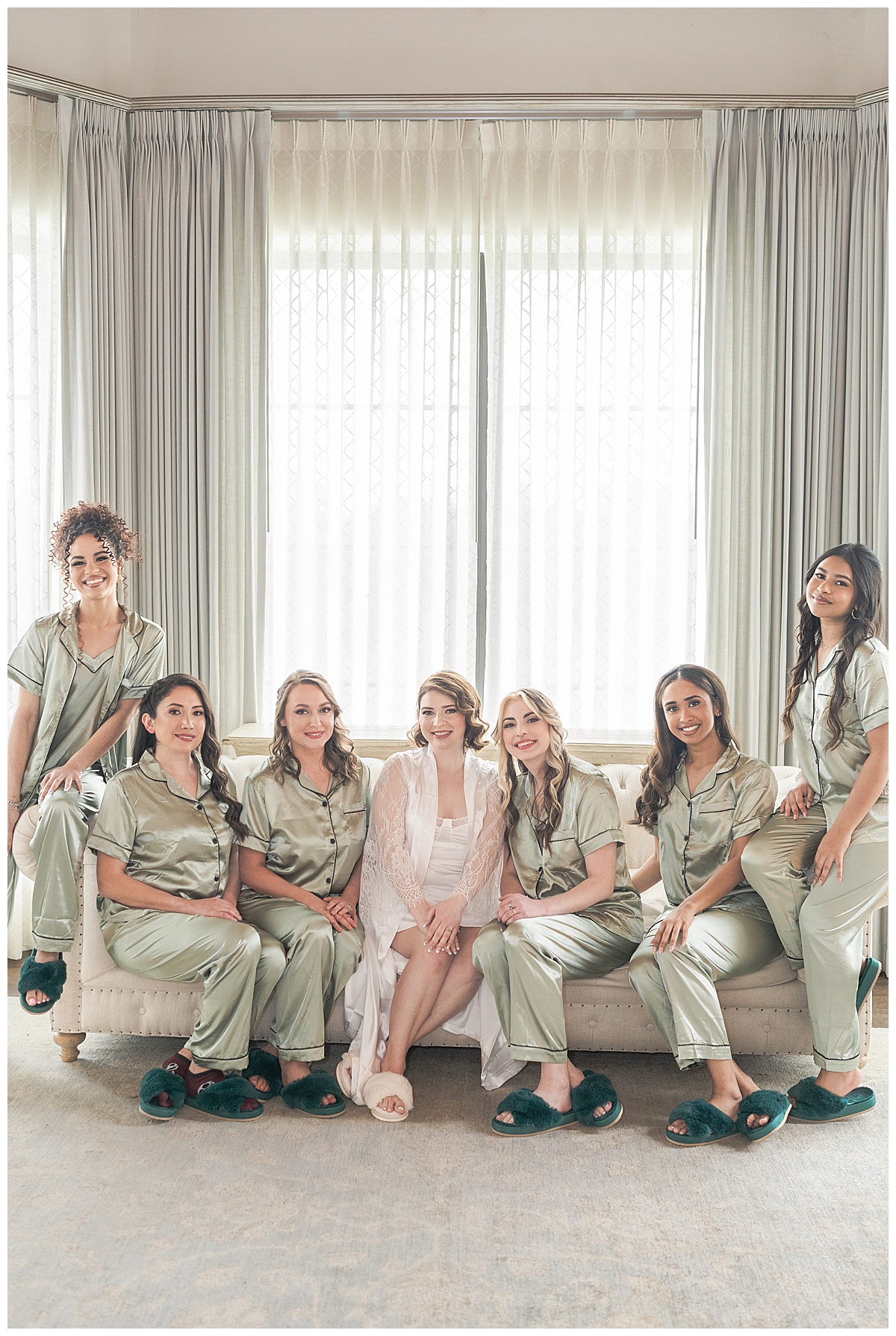 Bride sits near bridesmaids for Swish & Click Photography