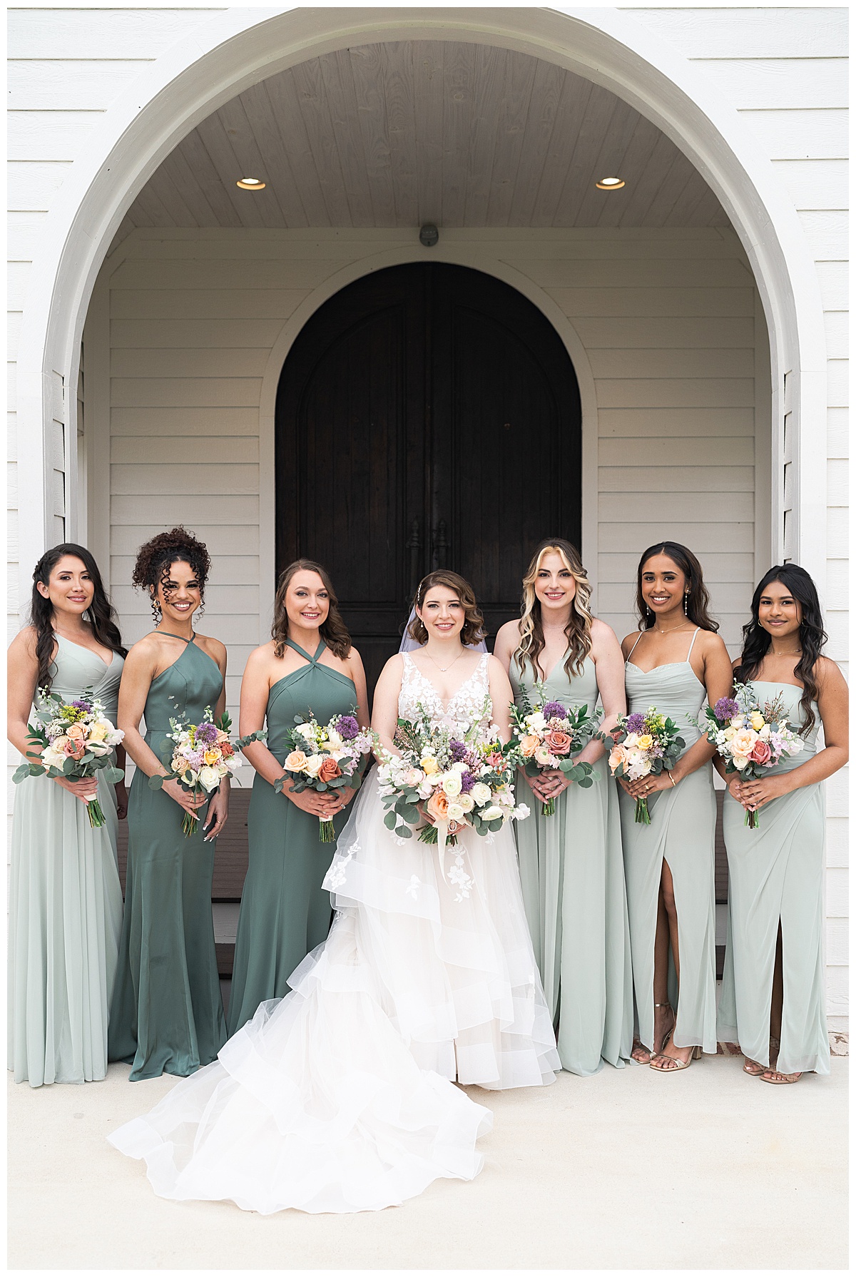 Bride stands with bridesmaids for Swish & Click Photography