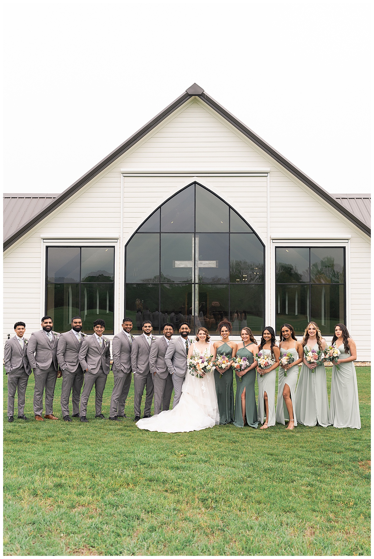 Family and friends stand among married couple for Swish & Click Photography