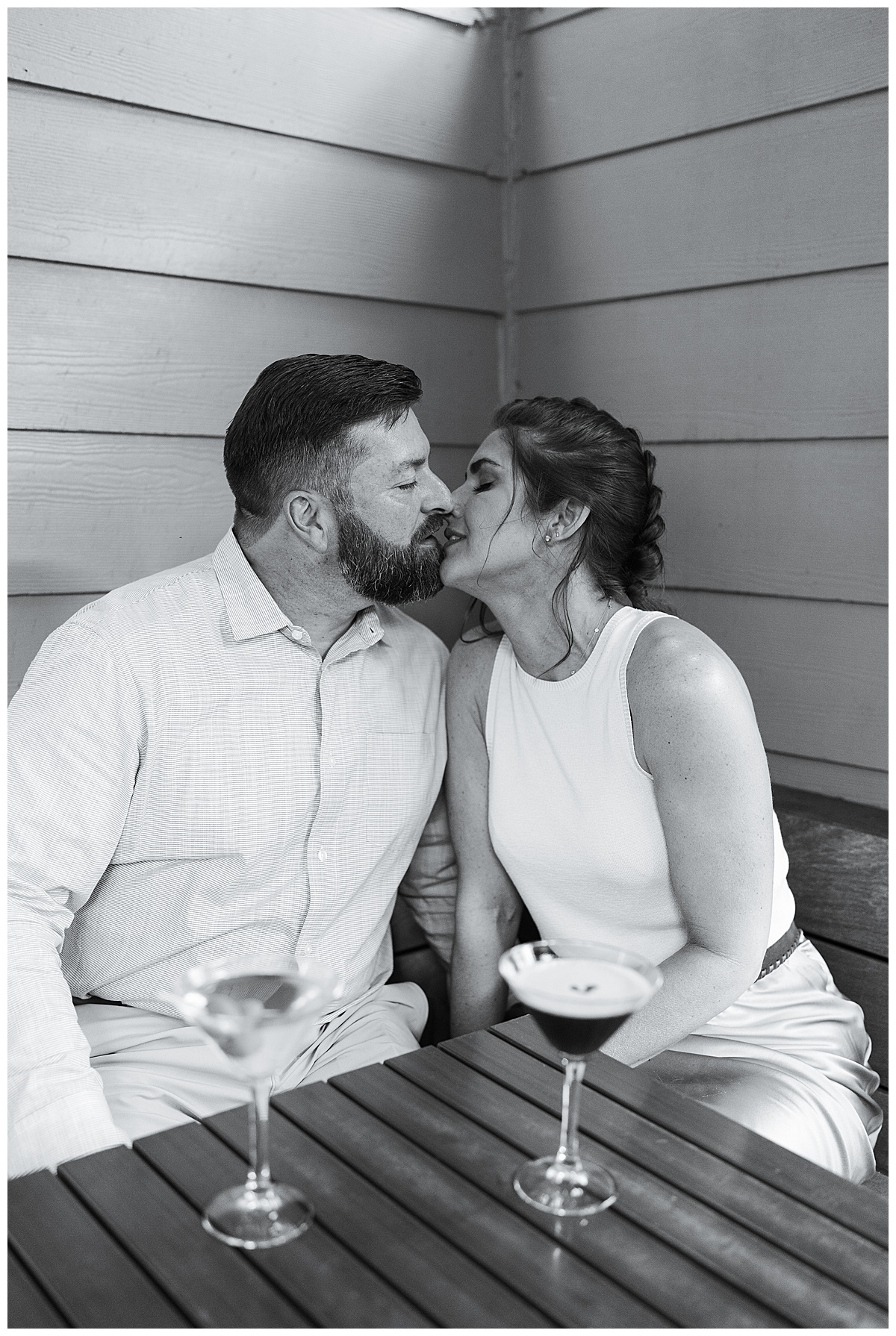 Two people share a kiss for Downtown Houston Engagement Session