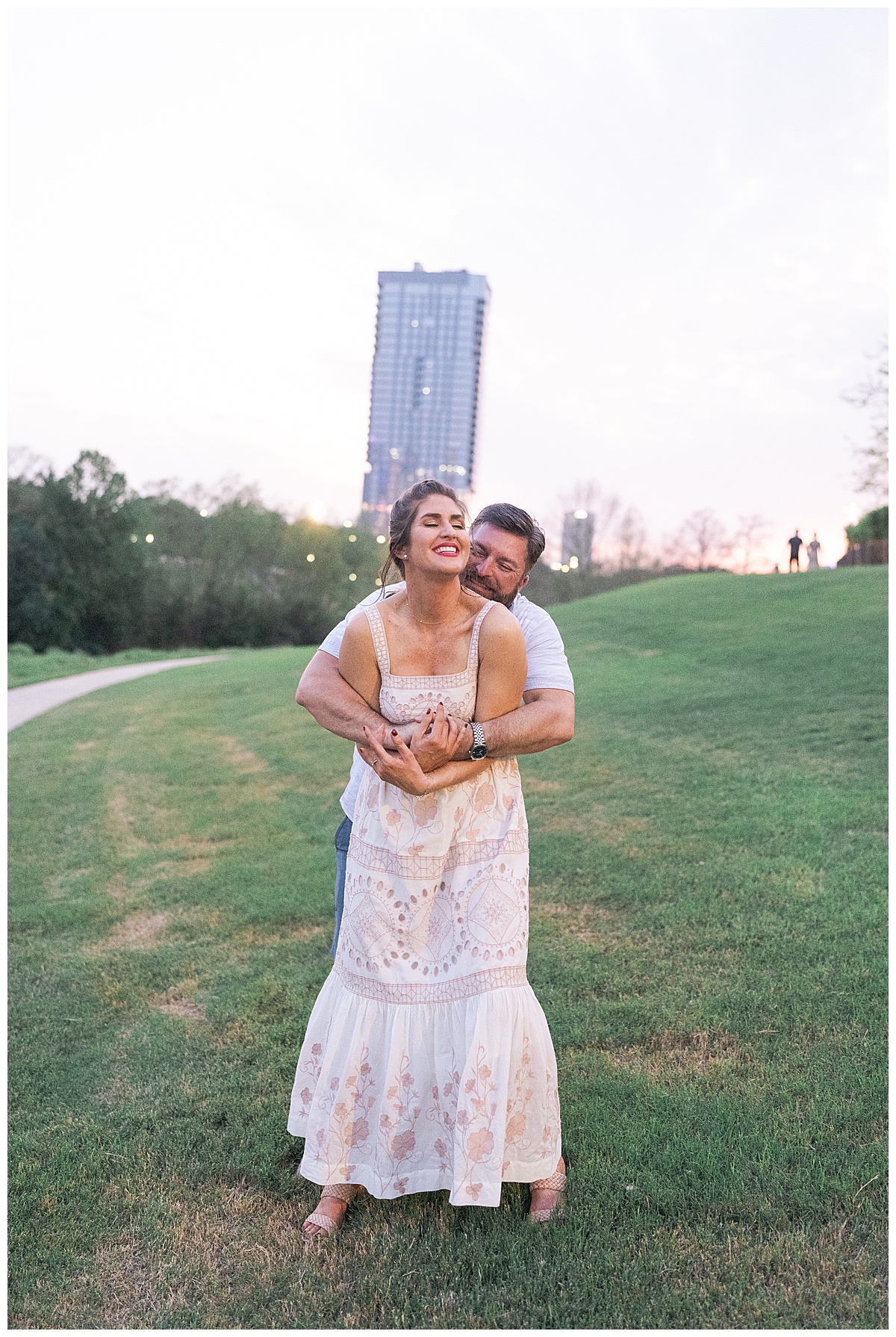 Couple hug one another close for Downtown Houston Engagement Session