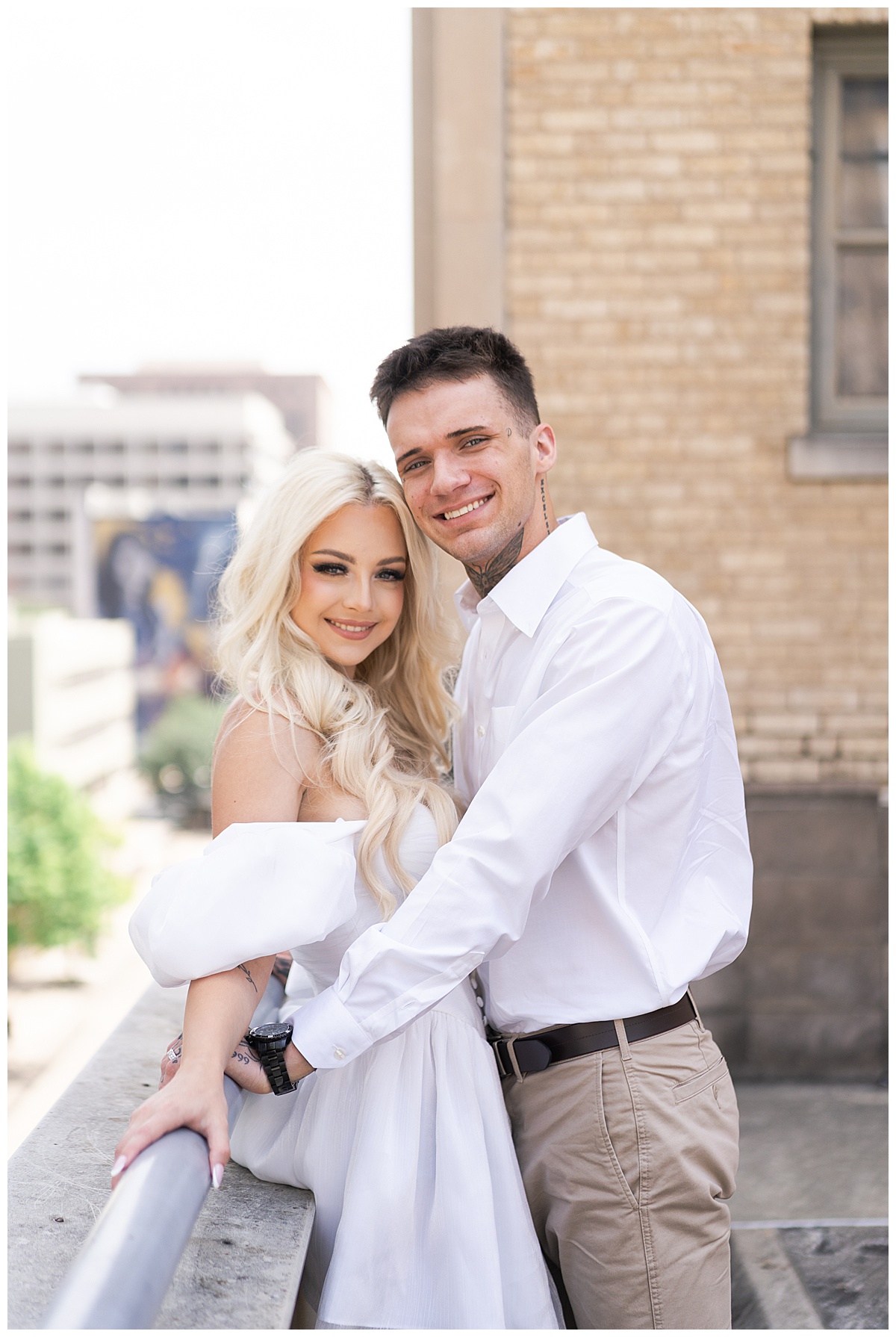 Couple share a tender moment together for Downtown Houston Rooftop Engagement Session