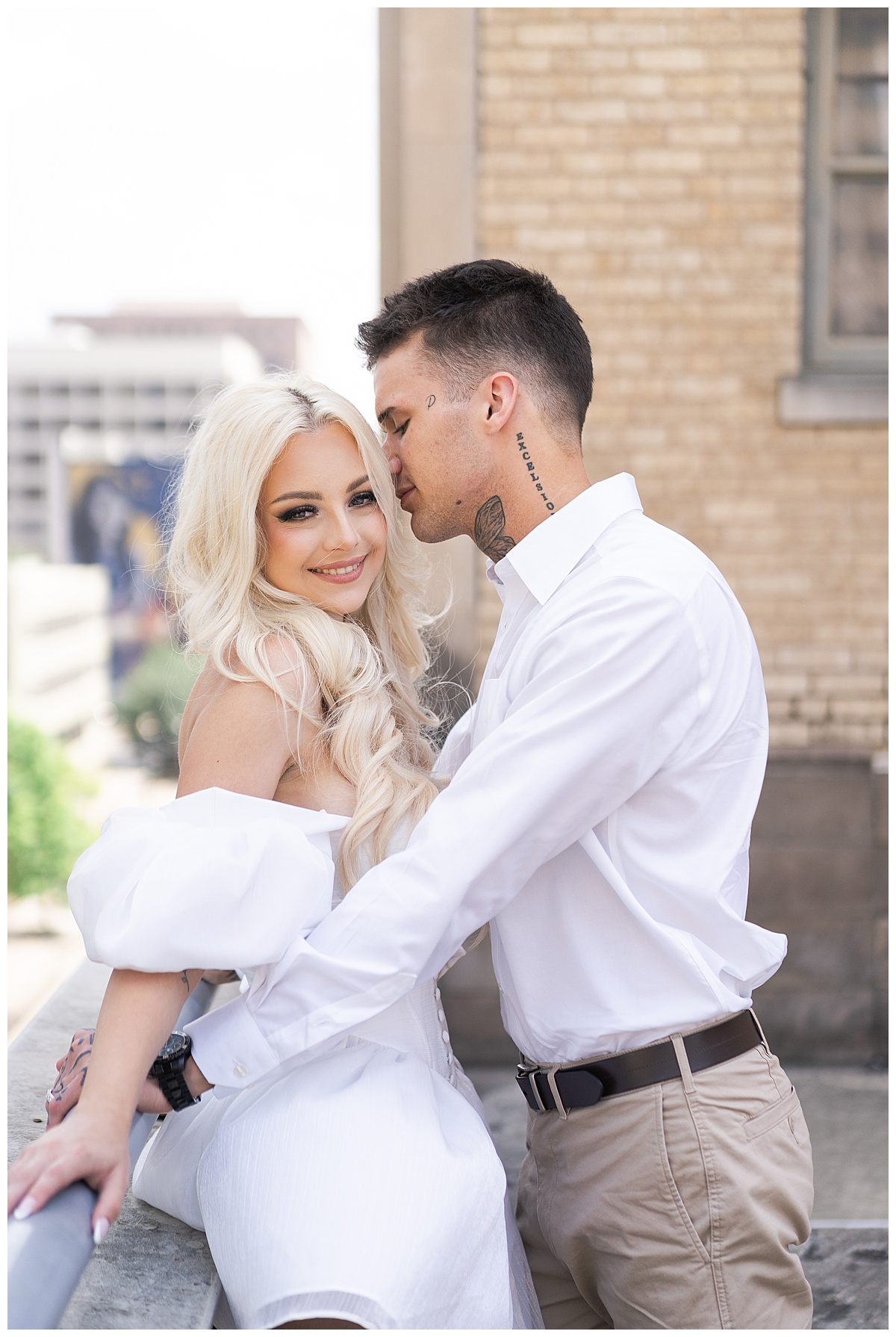 Man kisses woman for Downtown Houston Rooftop Engagement Session