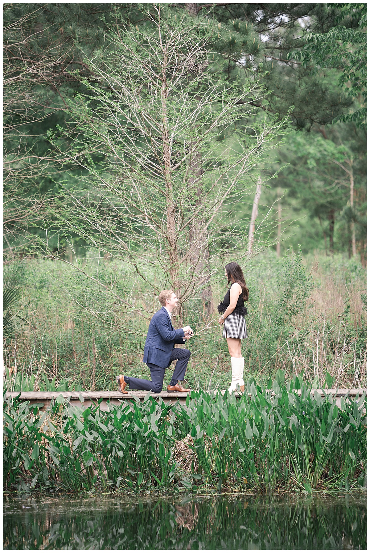 Guy down on one knee for Surprise Proposal at the Houston Arboretum