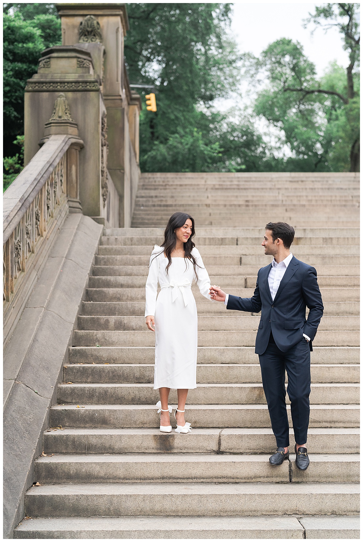 Man holds woman's hands down some stairs for Swish & Click Photography