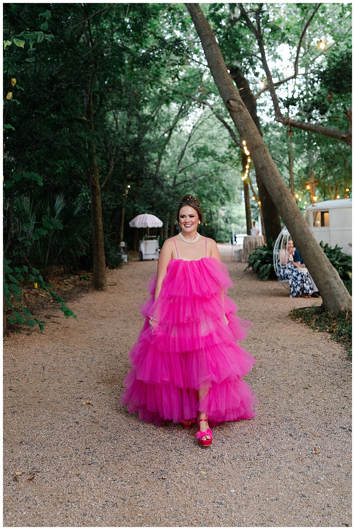 Woman walks in bright pink dress for Swish & Click Photography