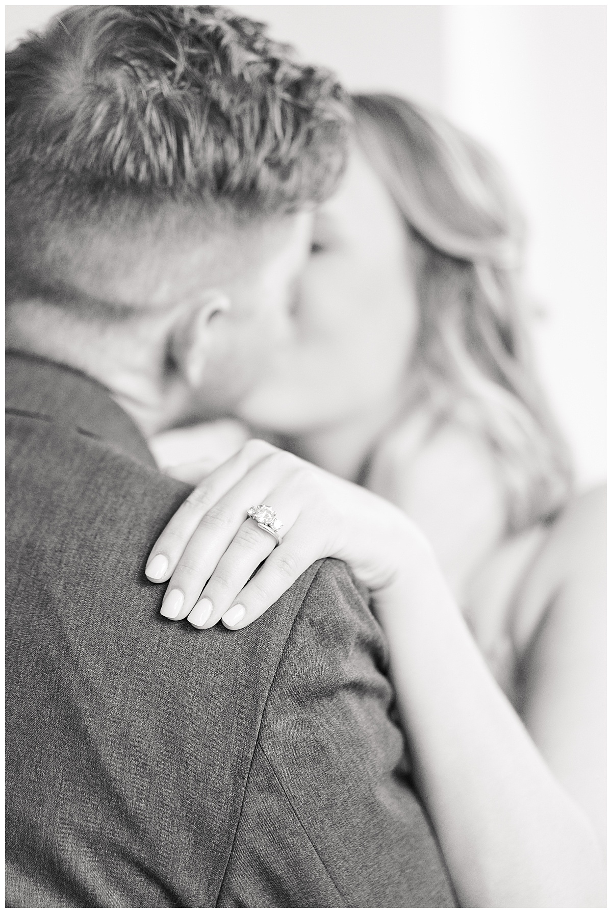 Woman's hand with engagement ring on man's shoulder during Houston Engagement session