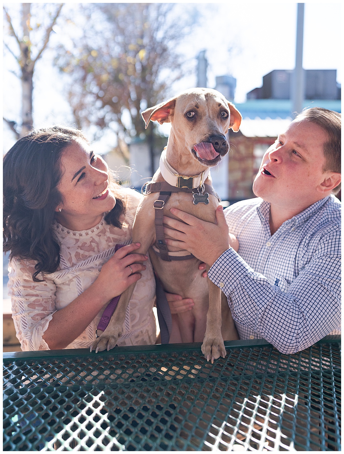 Couple smile with their dog for Swish & Click Photography