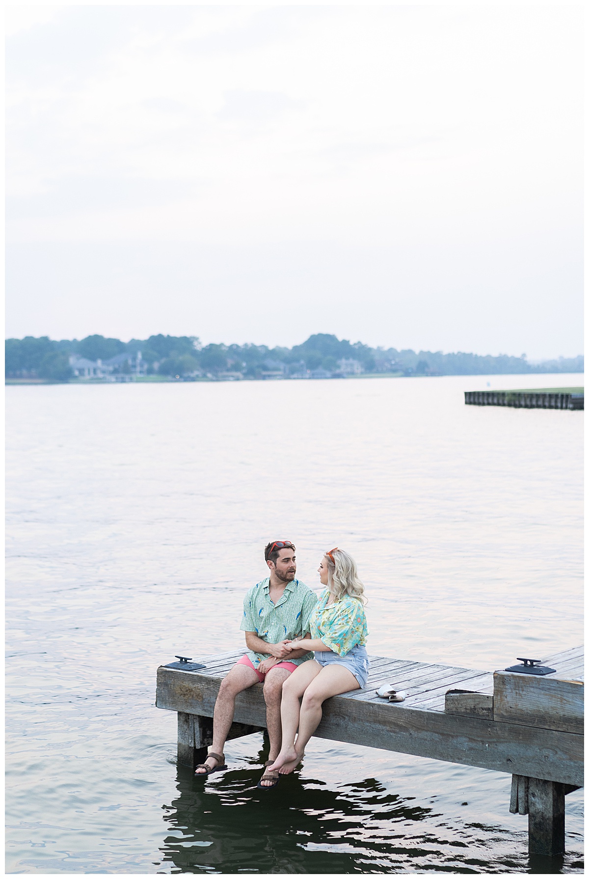 Couple sit on the dock together for Houston Engagement Photographer