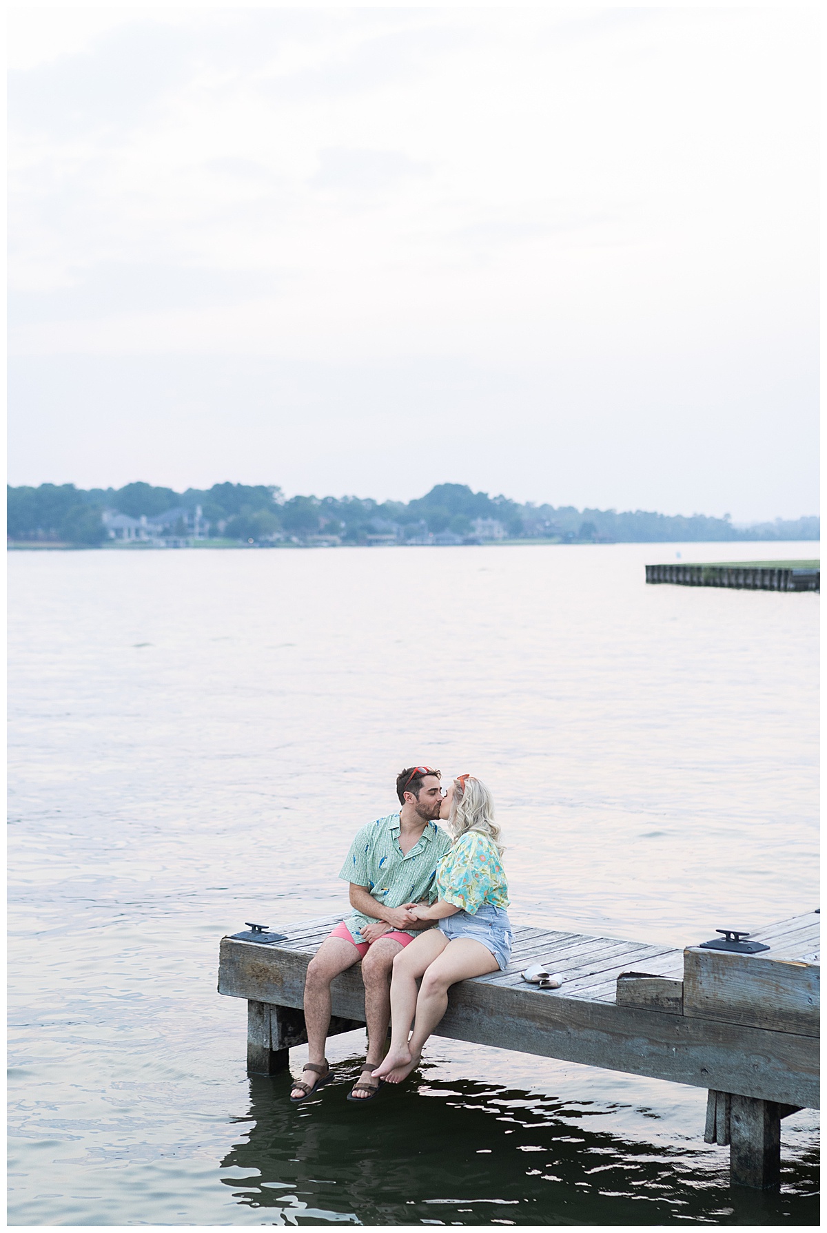 Man and woman sit on the dock together for Swish & Click Photography