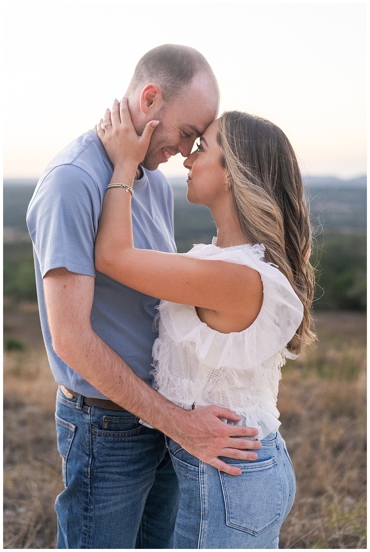 Man holds woman close during their Austin Engagement Session