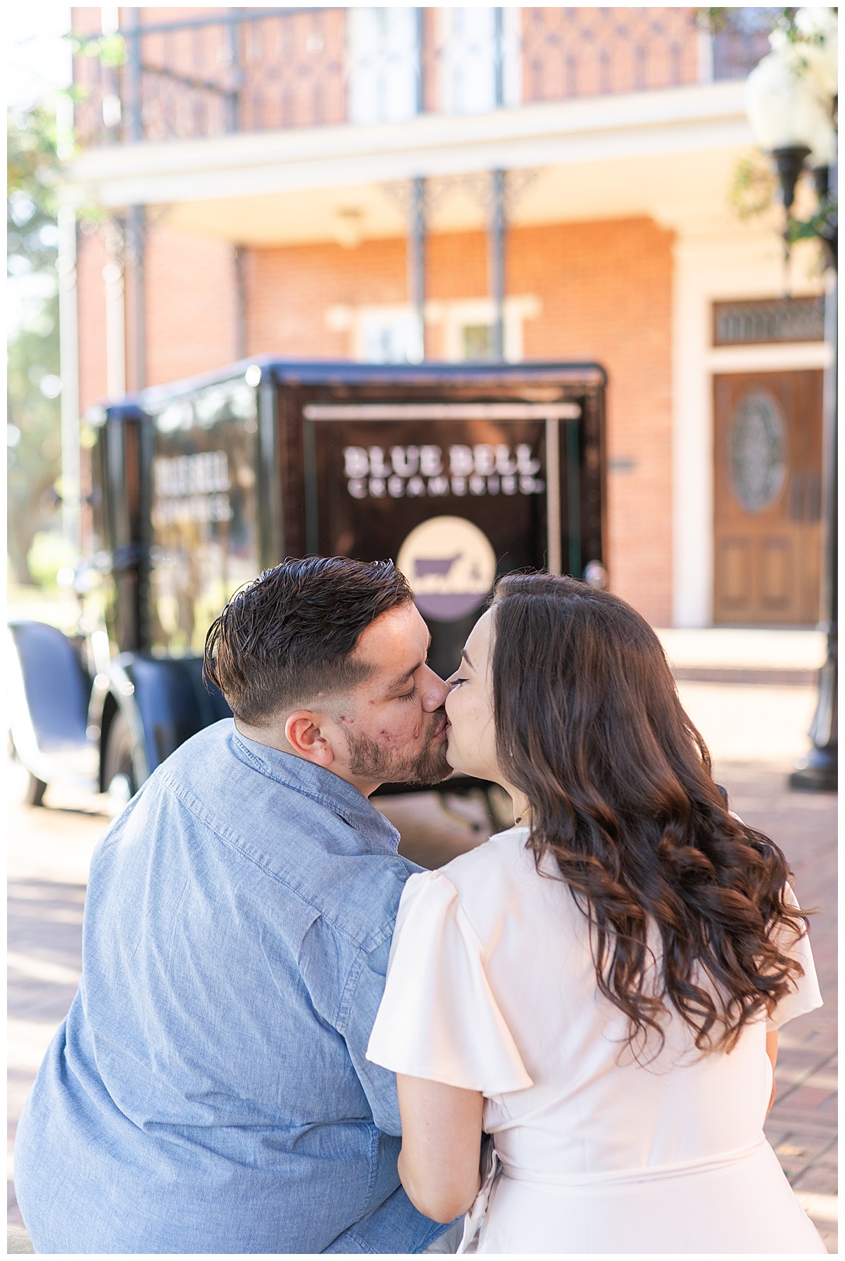 Man and woman share a kiss during Blue Bell Engagement Session