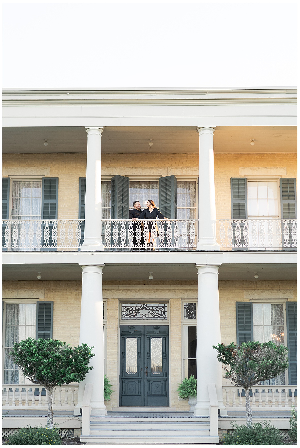 Couple stand on balcony together for Swish & Click Photography