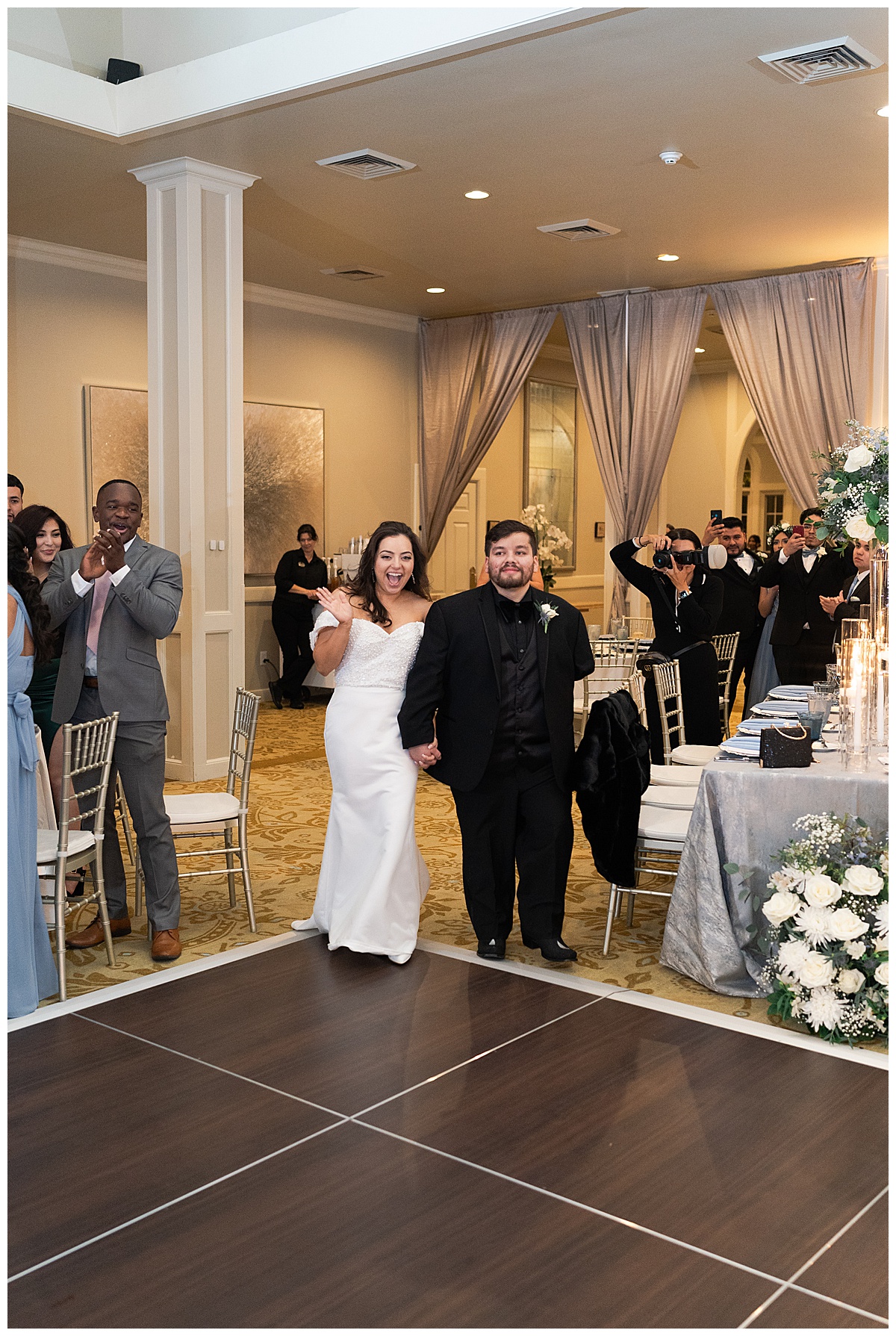 Couple walk into reception together for Houston’s Best Wedding Photographers
