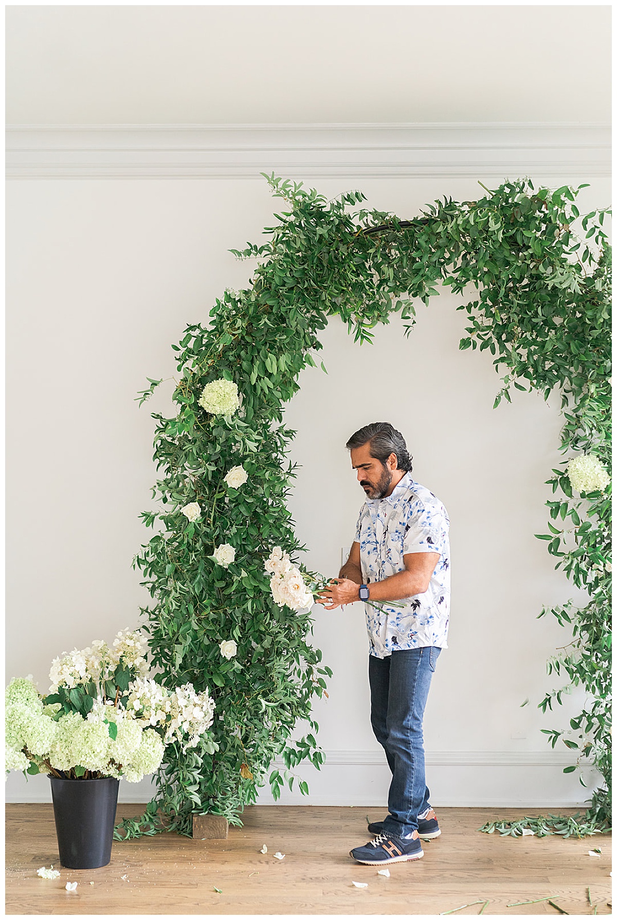 Man adds a flower into an arch for Houston’s Best Wedding Photographers