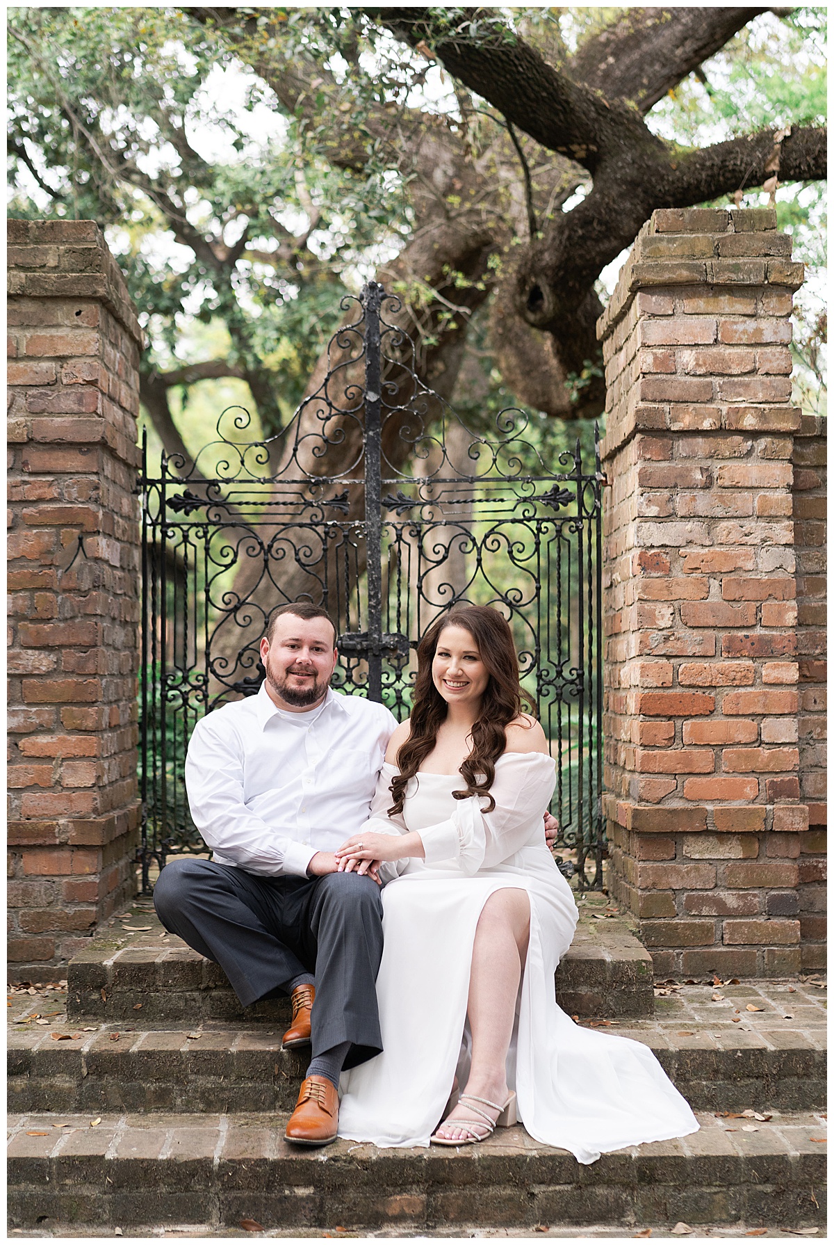 Man and woman sit close together during their Boulevard Oaks Engagement Session