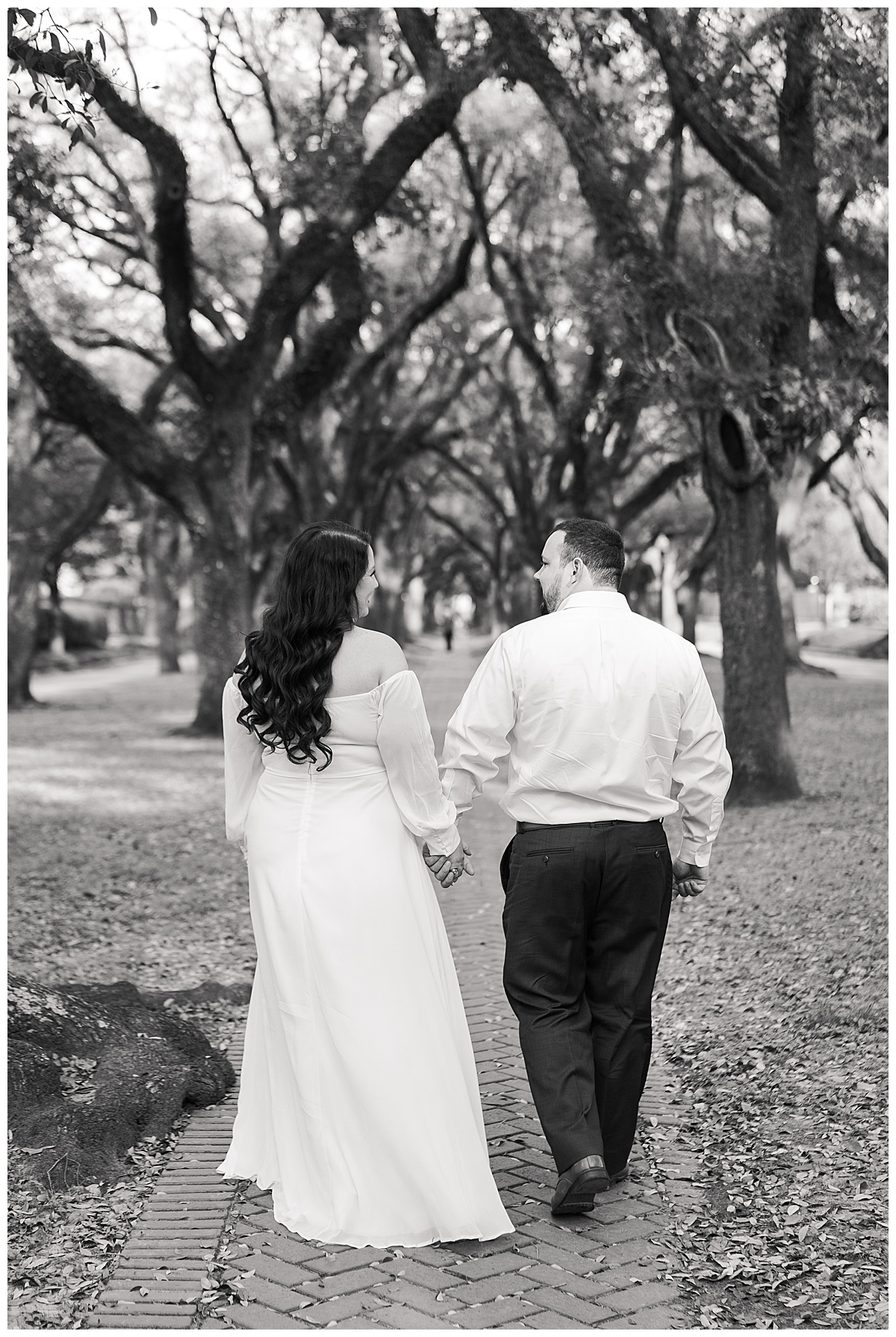 Man and woman walk together during their Boulevard Oaks Engagement Session