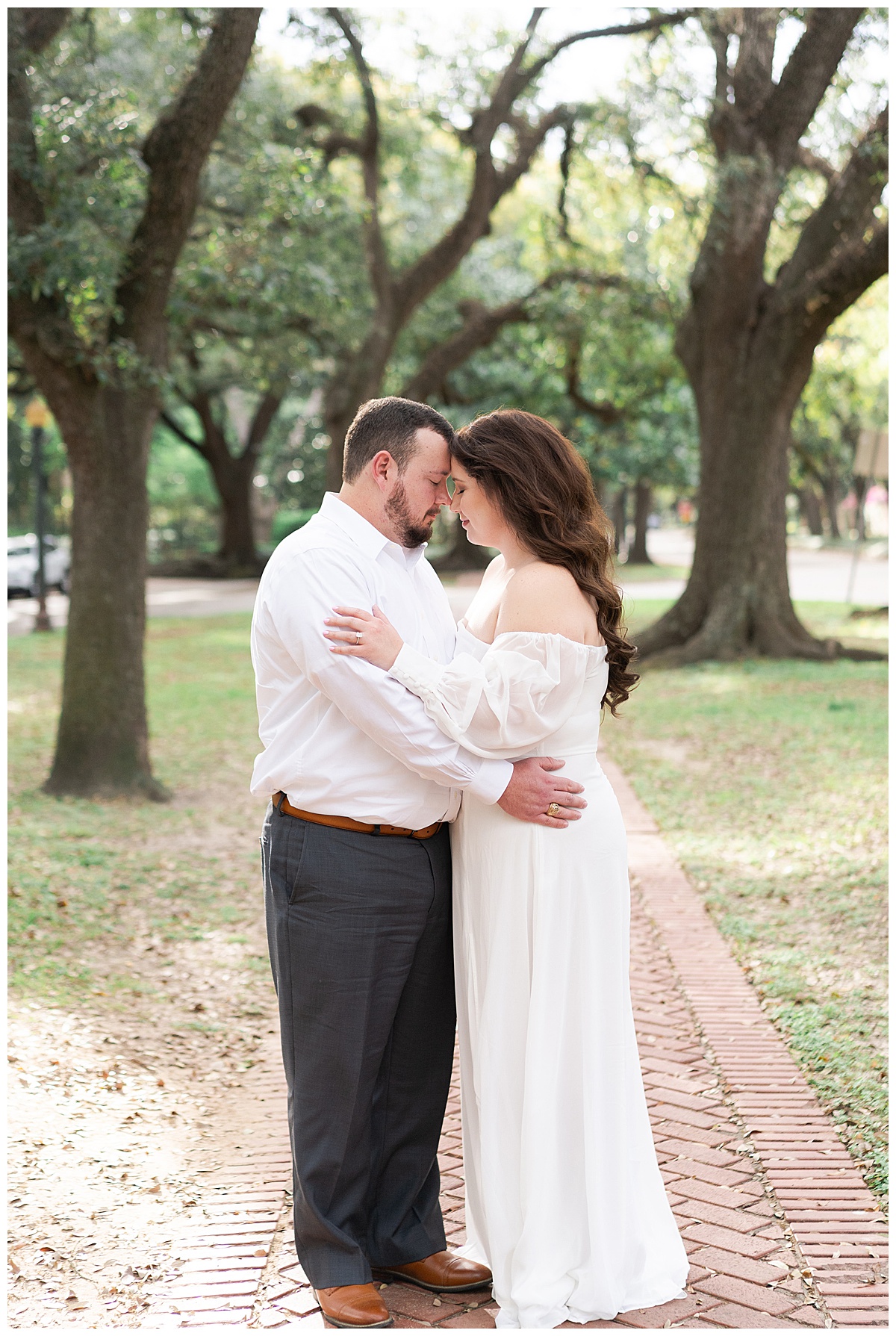 Man and woman holds each other close during their Boulevard Oaks Engagement Session