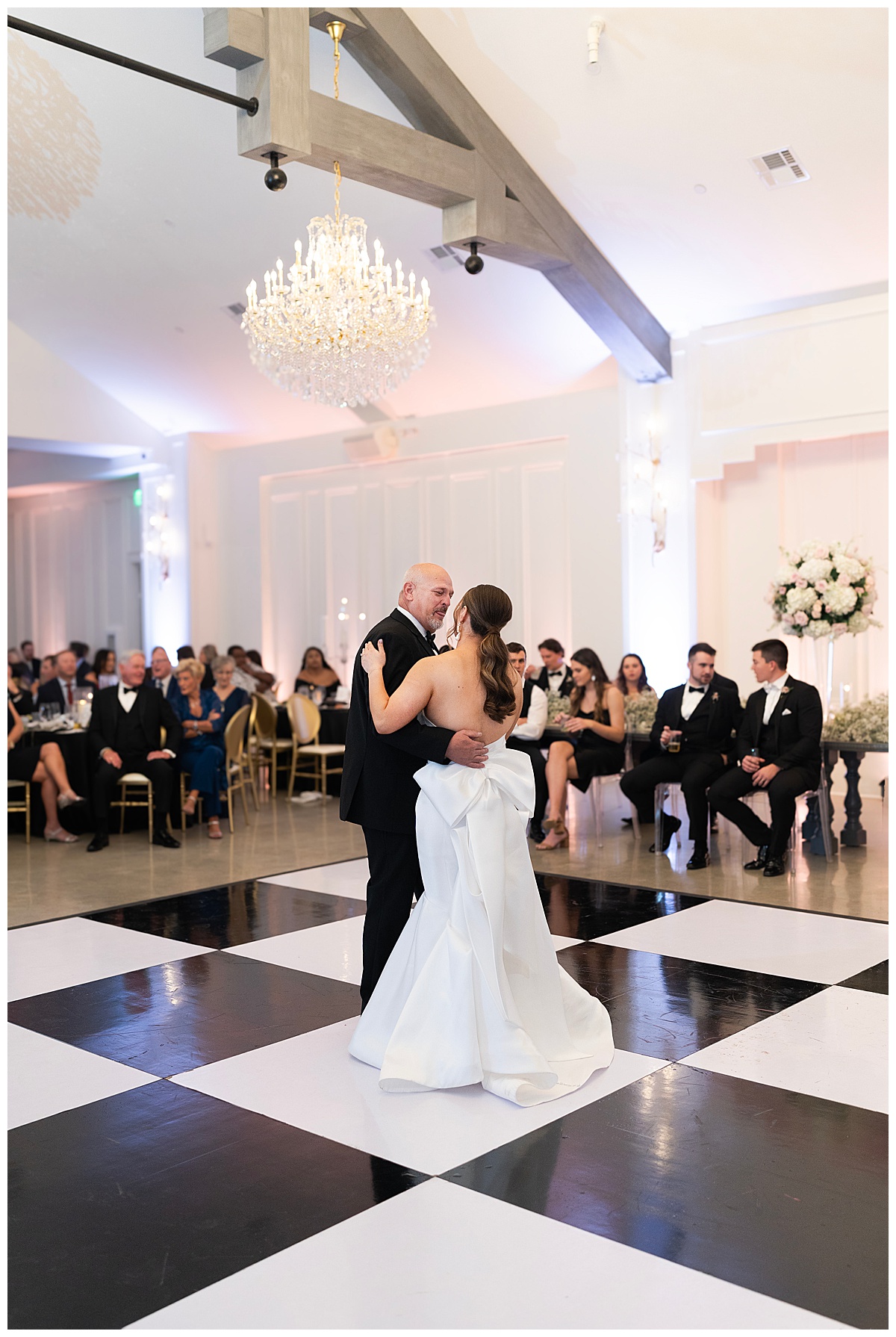 Two people dance on checkered dance floor showing off 70's Inspired Wedding Ideas