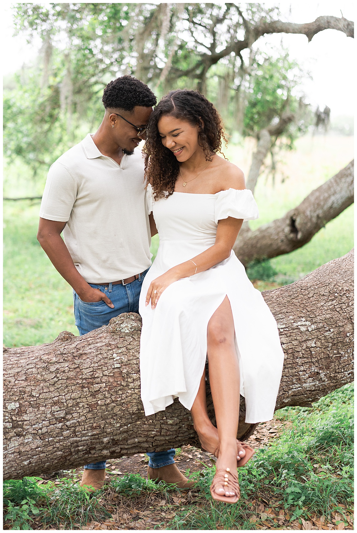 Two people couple together on tree during Brazos Bend Engagement Photographer 