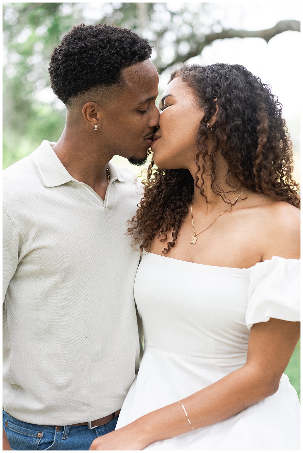 Couple share a kiss together during their Brazos Bend Engagement Photographer 