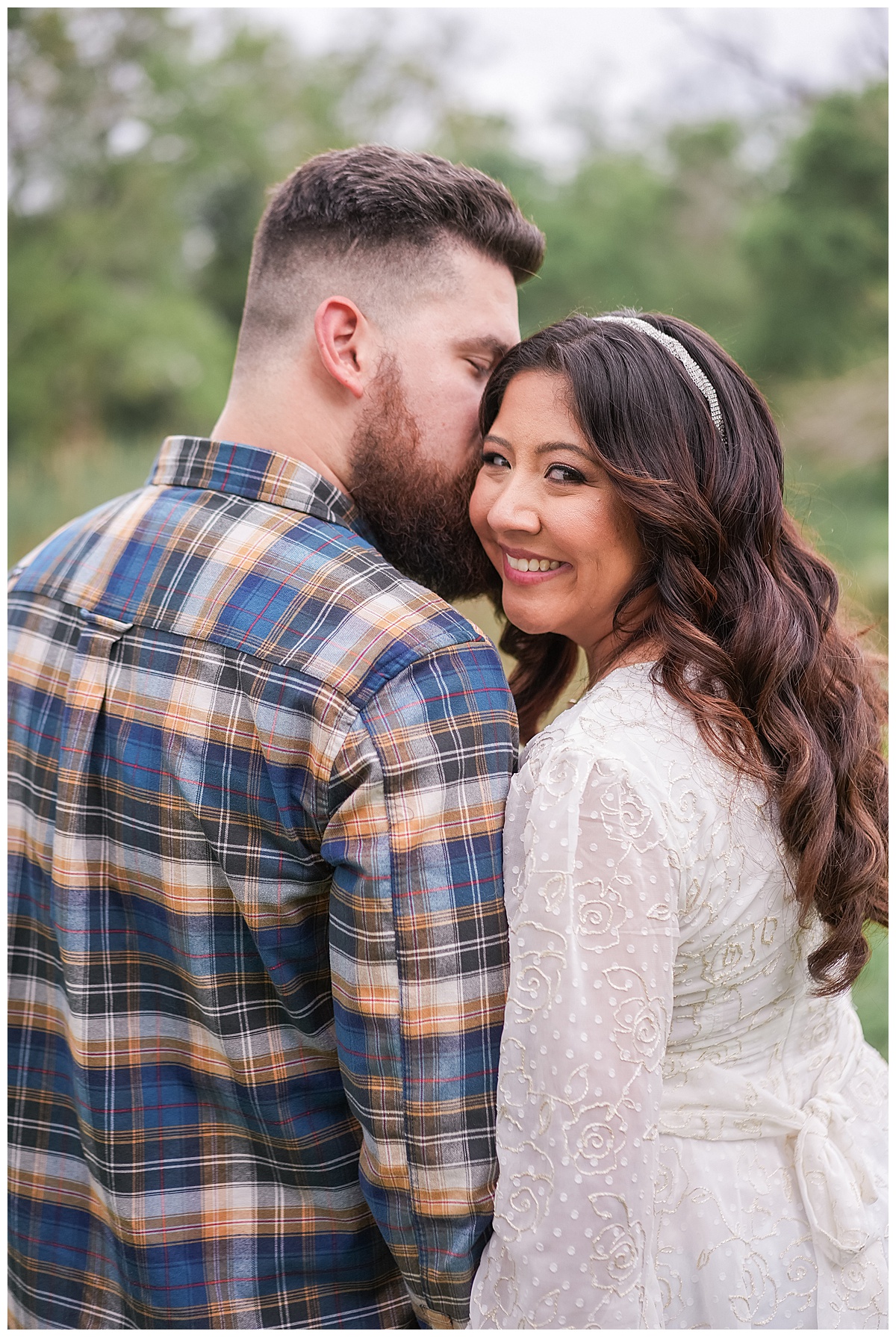 Man kisses woman on the cheek during their Houston Disney Engagement Session