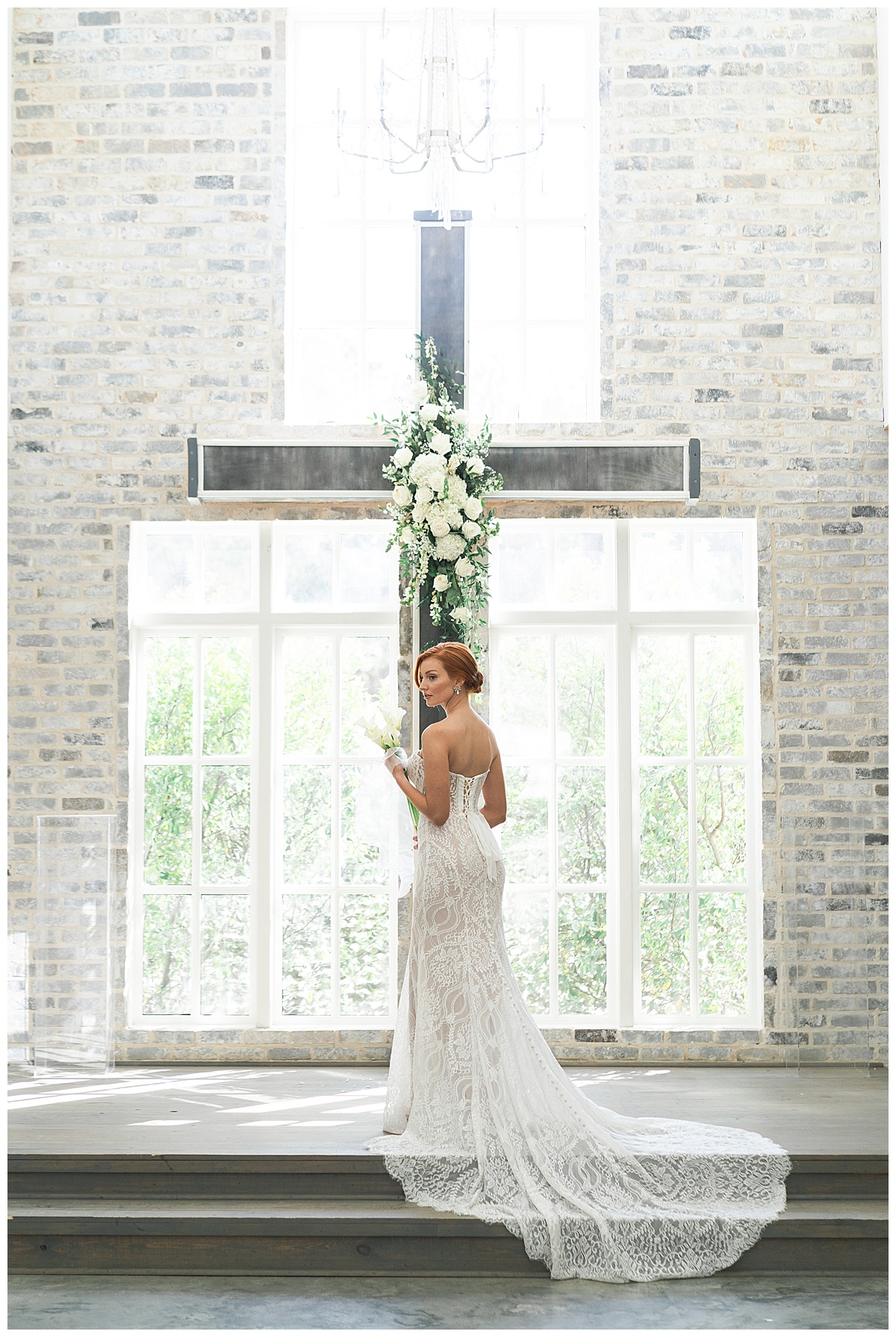 Bride stands in front of wedding chapel cross by Houston’s Best Wedding Photographers