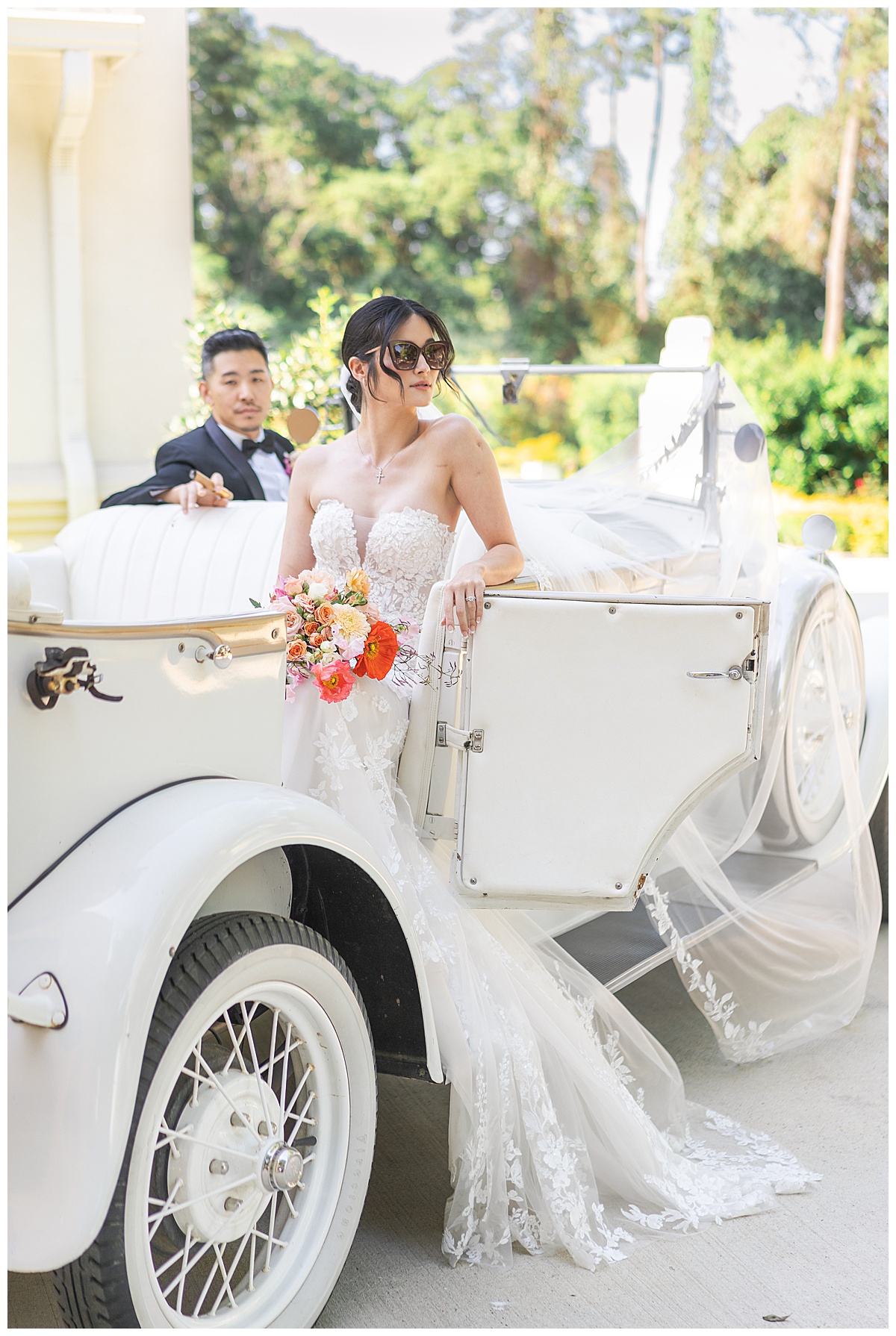 Couple sit in wedding car together by Swish & Click Photography