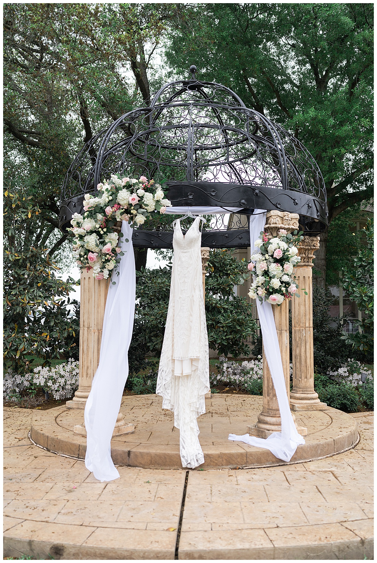 Wedding bridal gown on ceremony arch for Swish & Click Photography