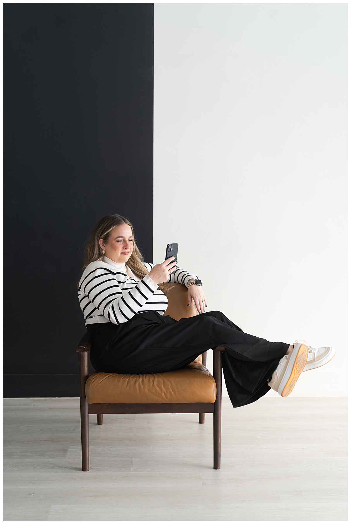 Woman sits on the couch with her phone for Houston Editorial Branding Photographer