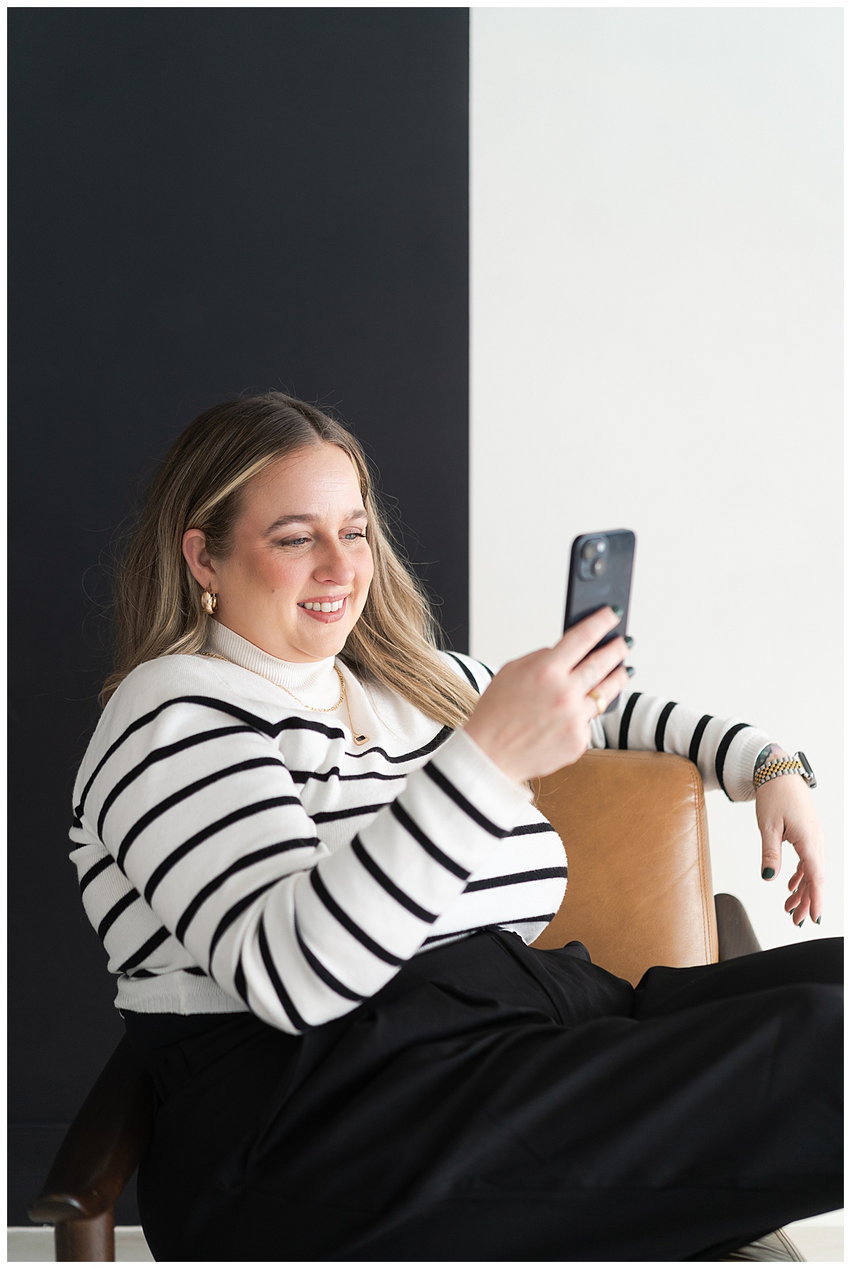 Adult smiles at her phone for Houston Editorial Branding Photographer
