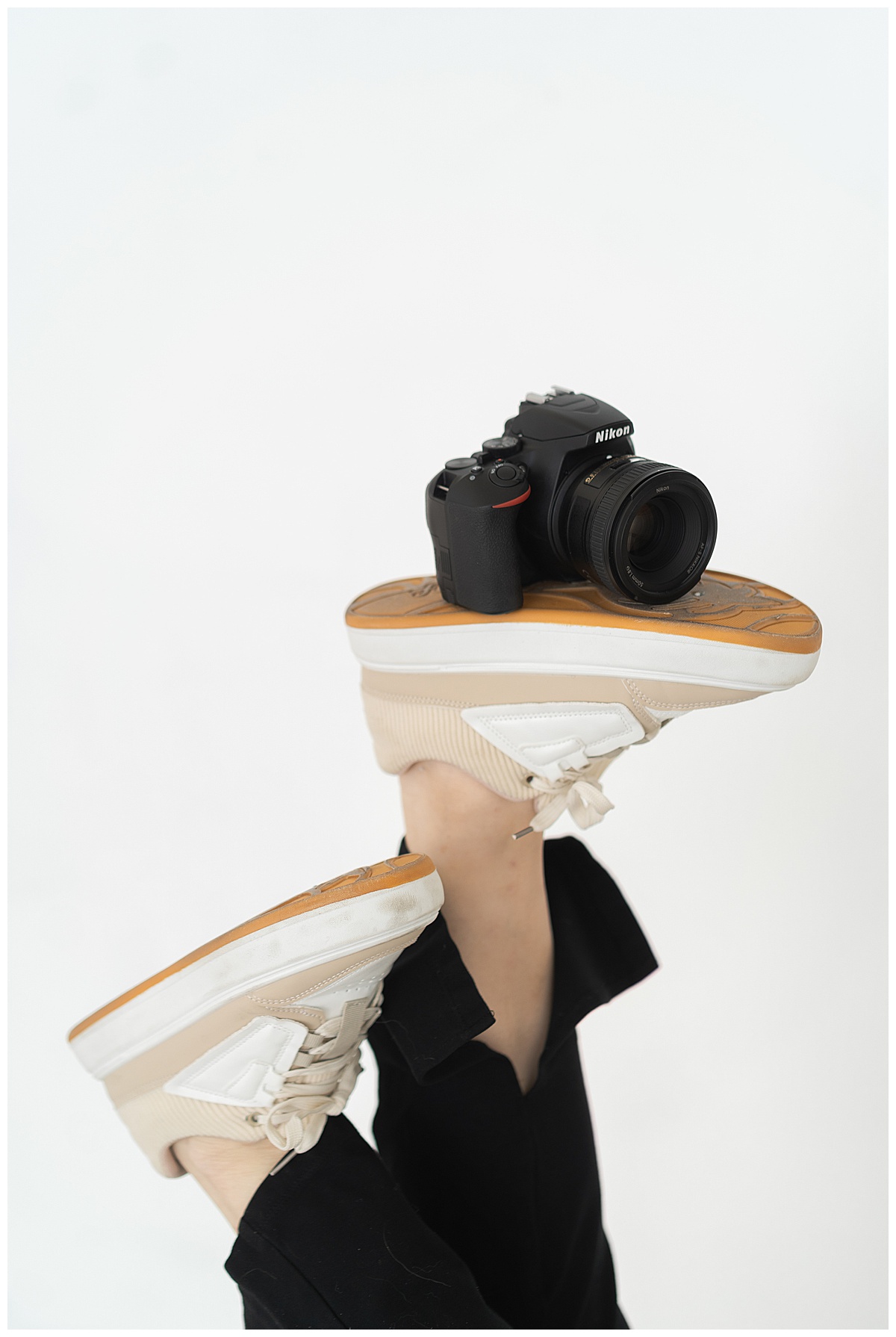 Person holds camera on her shoes for Swish & Click Photography