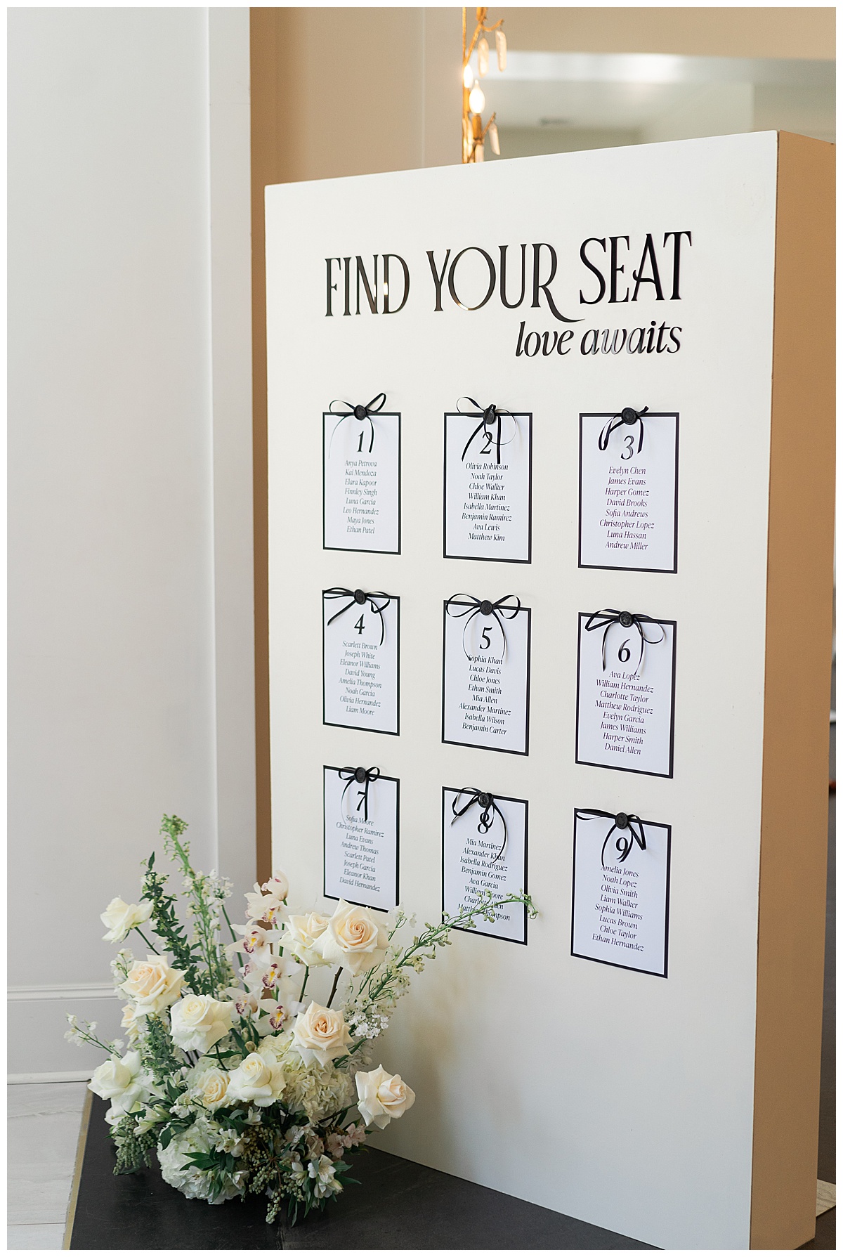 one of the 2025 Wedding Trends to look forward to is bows on decor like the custom seating chart