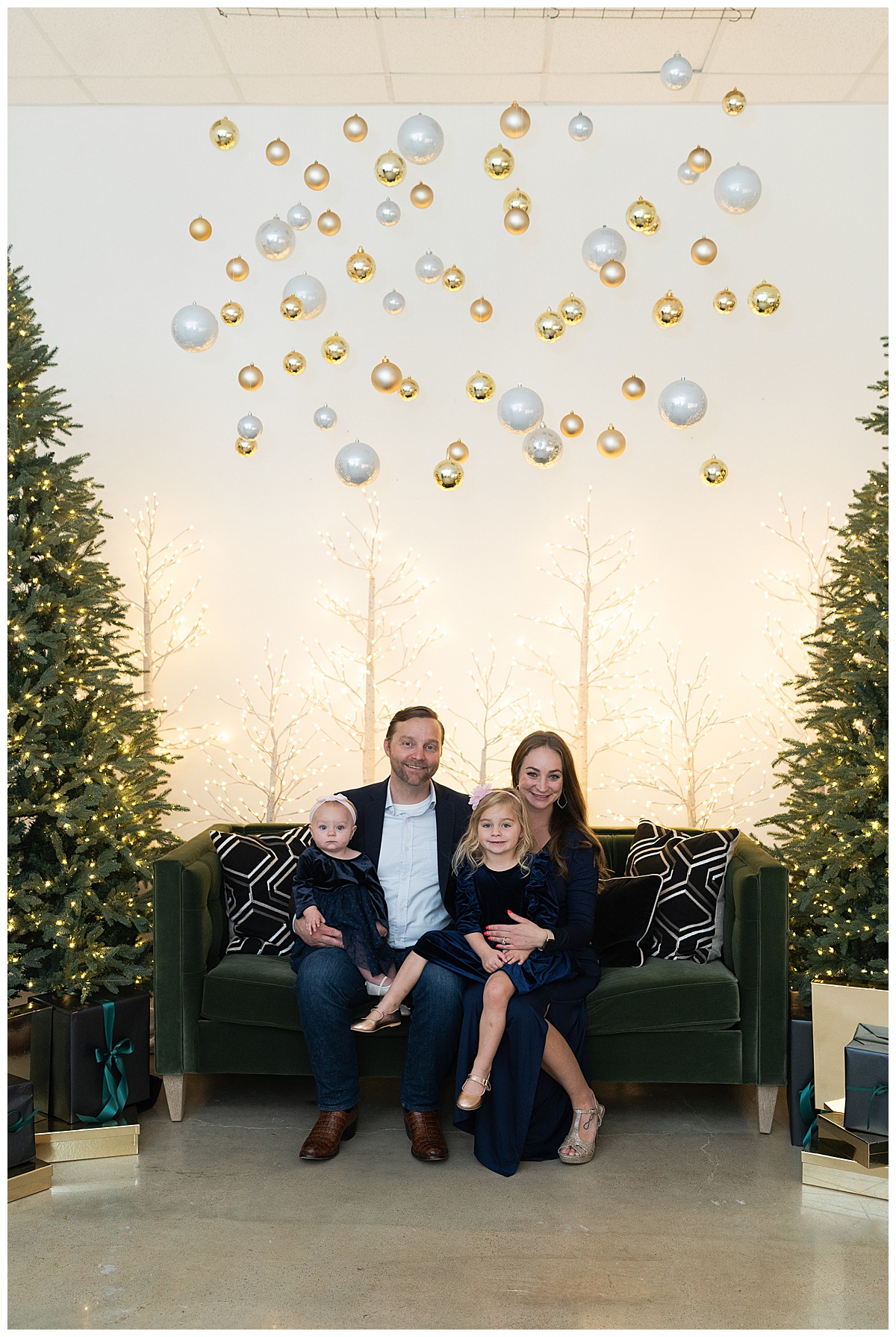 Family sit together on the couch during Christmas Minis In Houston