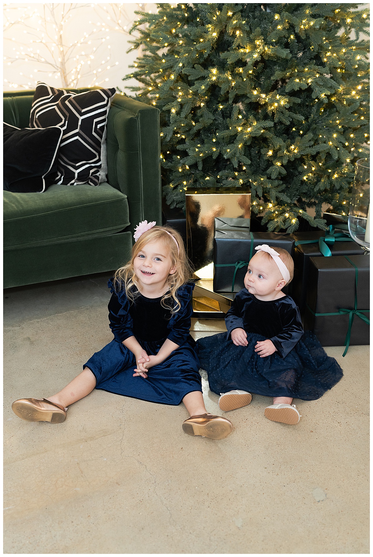 Young kinds sit in front of Christmas trees for Swish & Click Photography