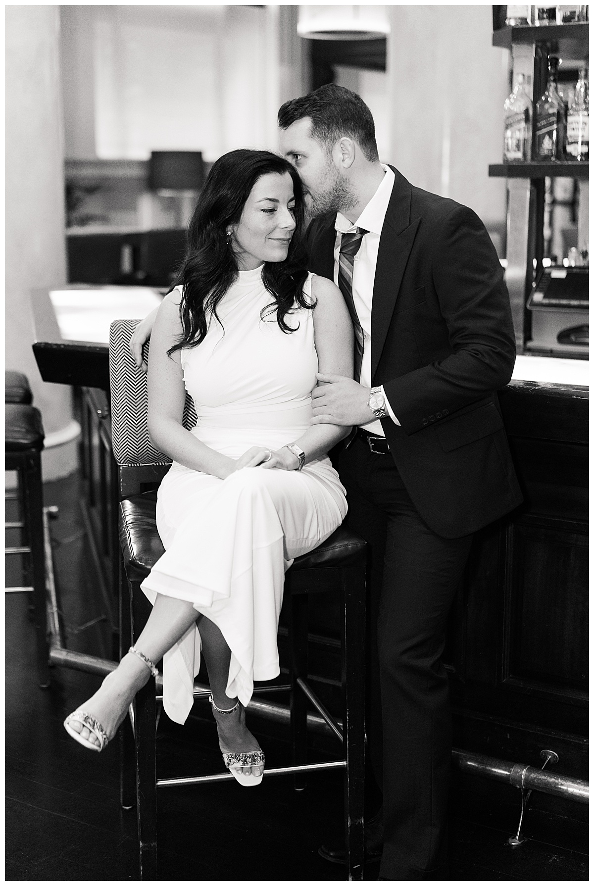 Man and woman sit together for Hotel Icon Engagement Session