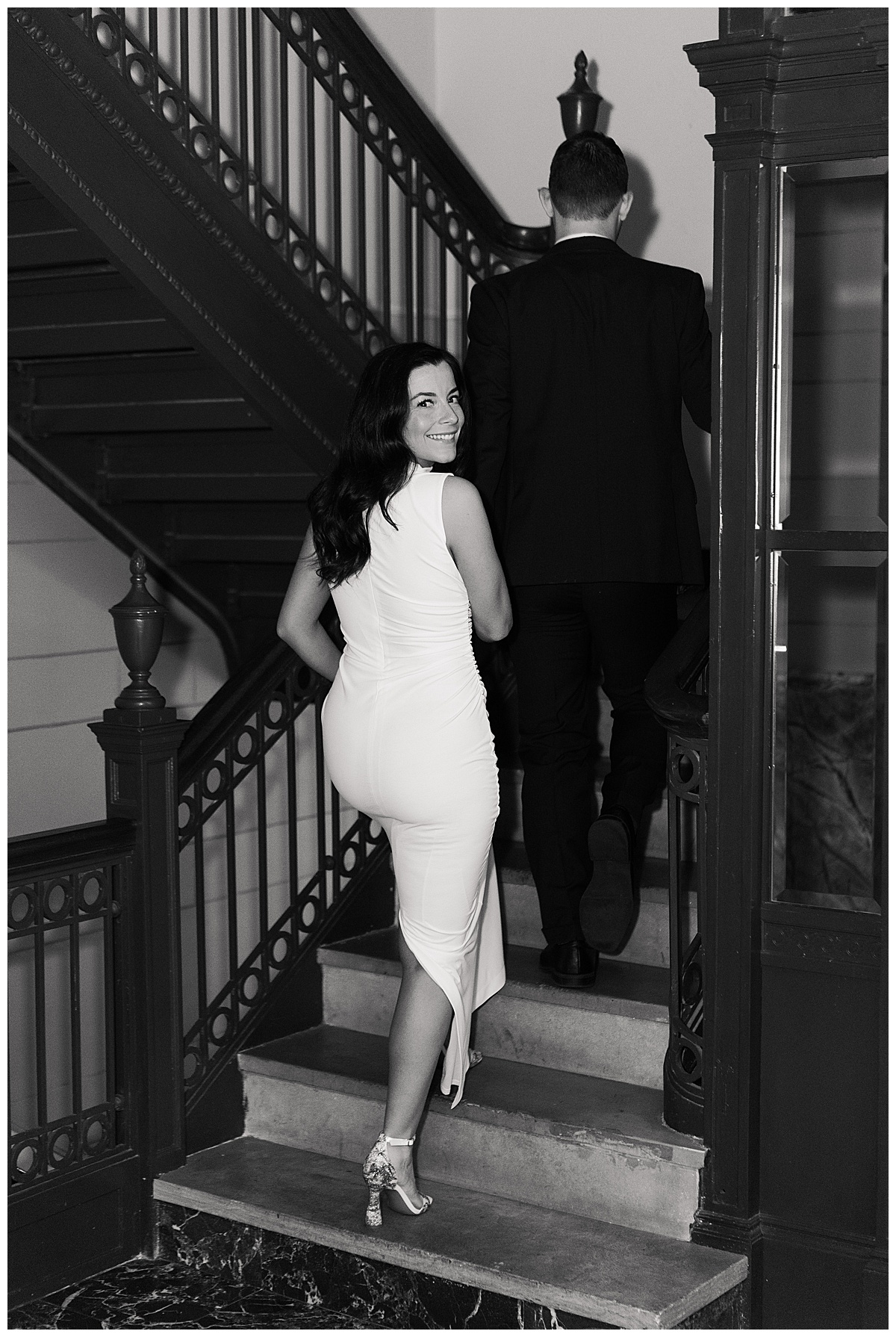 Couple walk together on the stairs for Hotel Icon Engagement Session