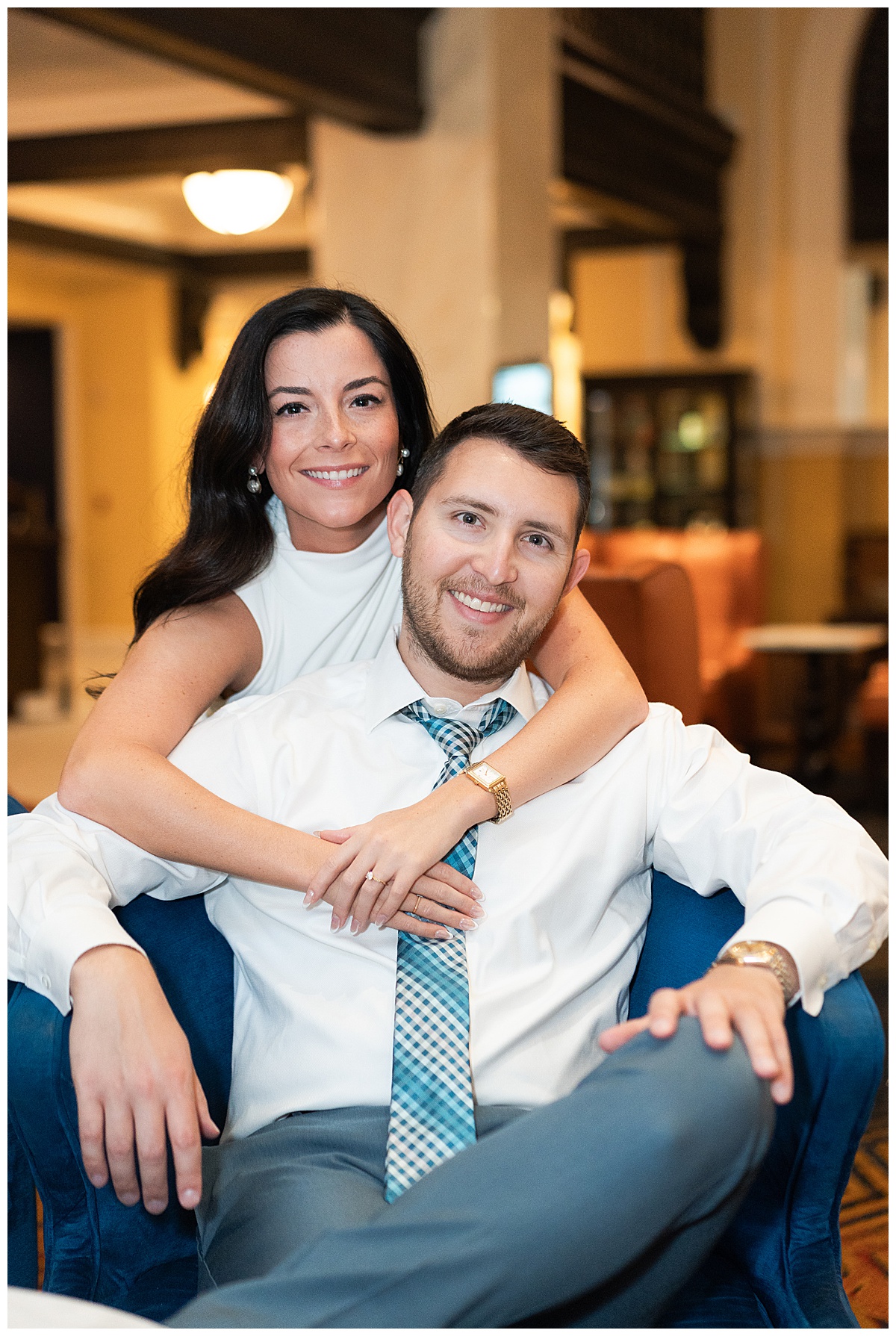 Woman holds man close for Hotel Icon Engagement Session